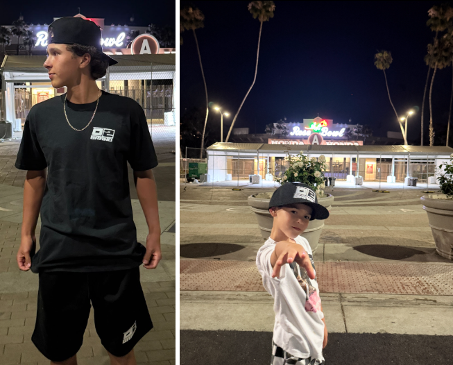 Two boys model 0-2 Brand Merchandise, a hat, shirt, and shorts