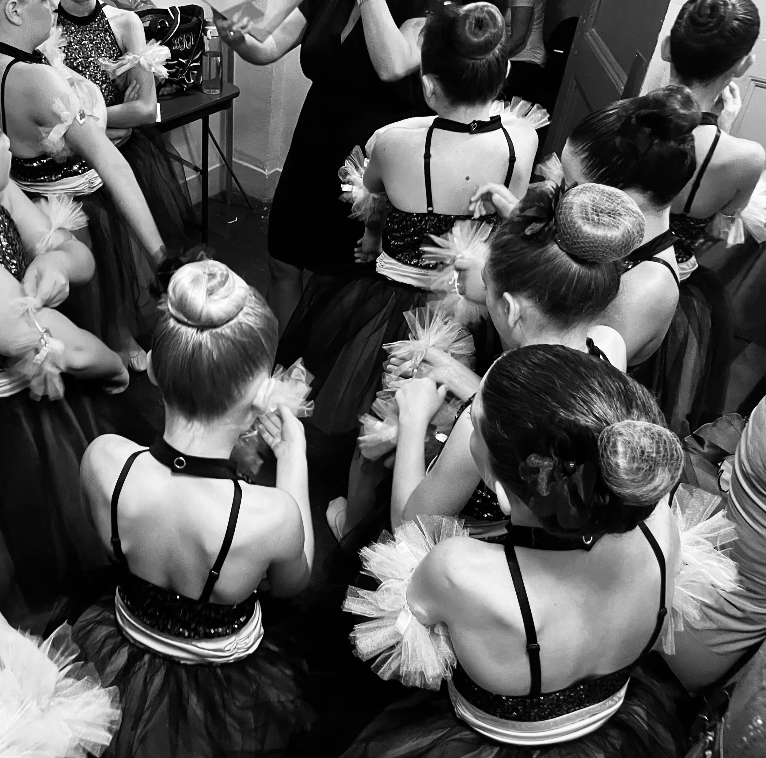 Dance students preparing backstage for a recital