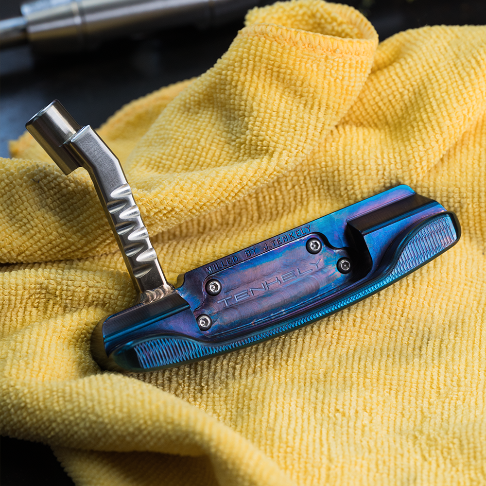 Legacy Goods milled custom putter with blue torched finish and copper face insert created by Jonathan Tenkely.