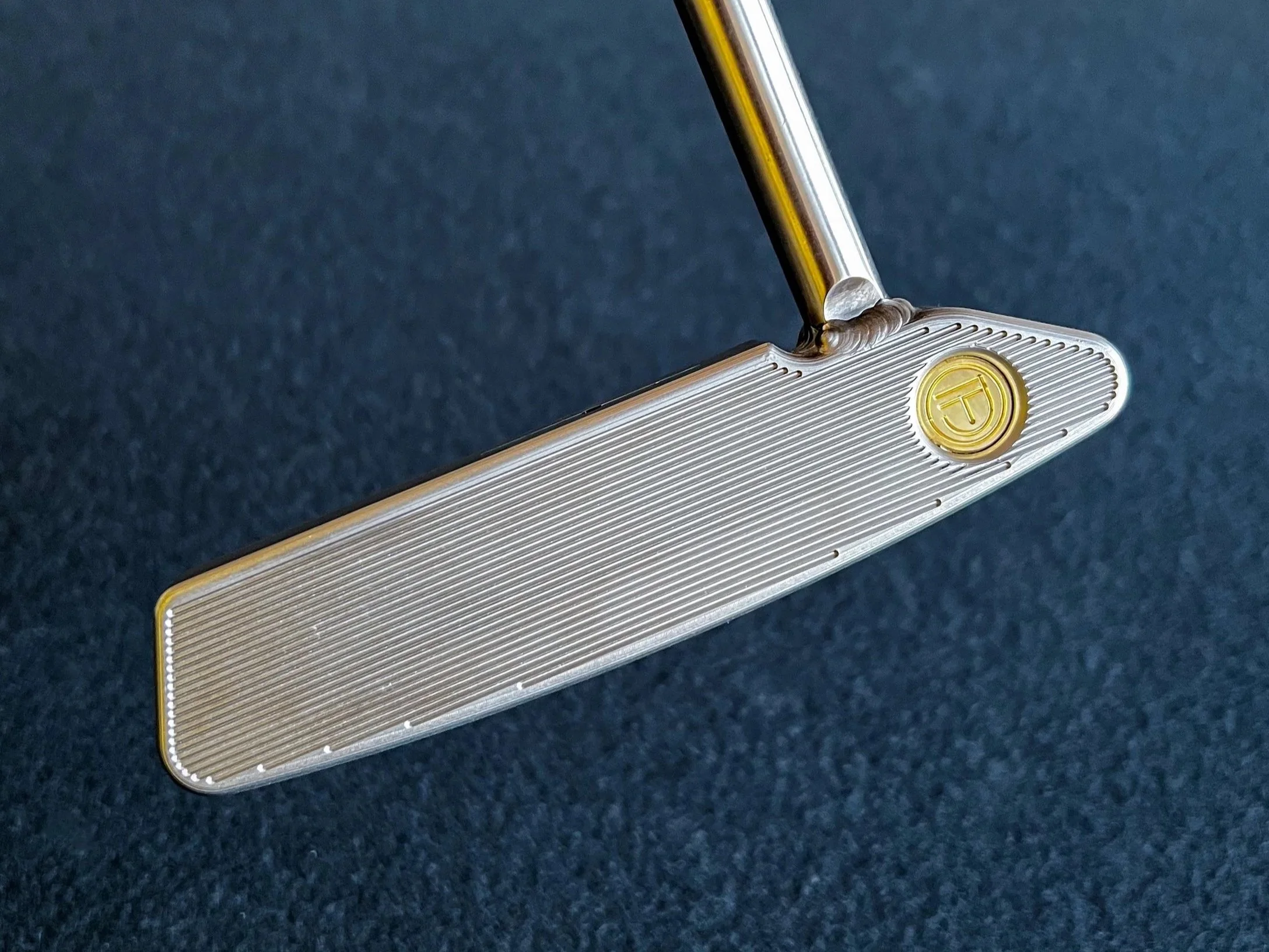 A Legacy Goods CNC milled Theo stainless steel custom putter with face milled grooves