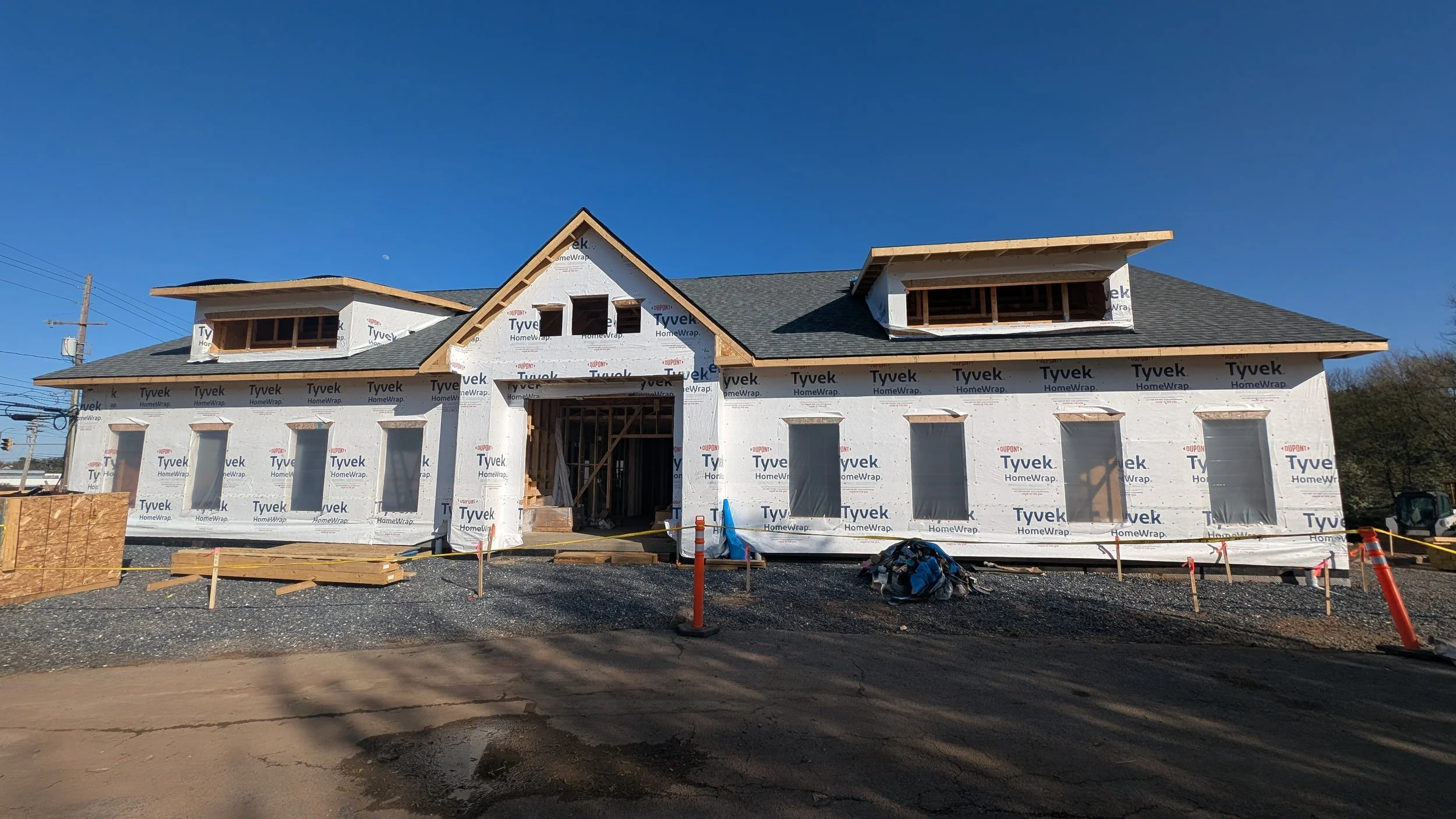 Under construction house with Tyvek wrap and multiple windows