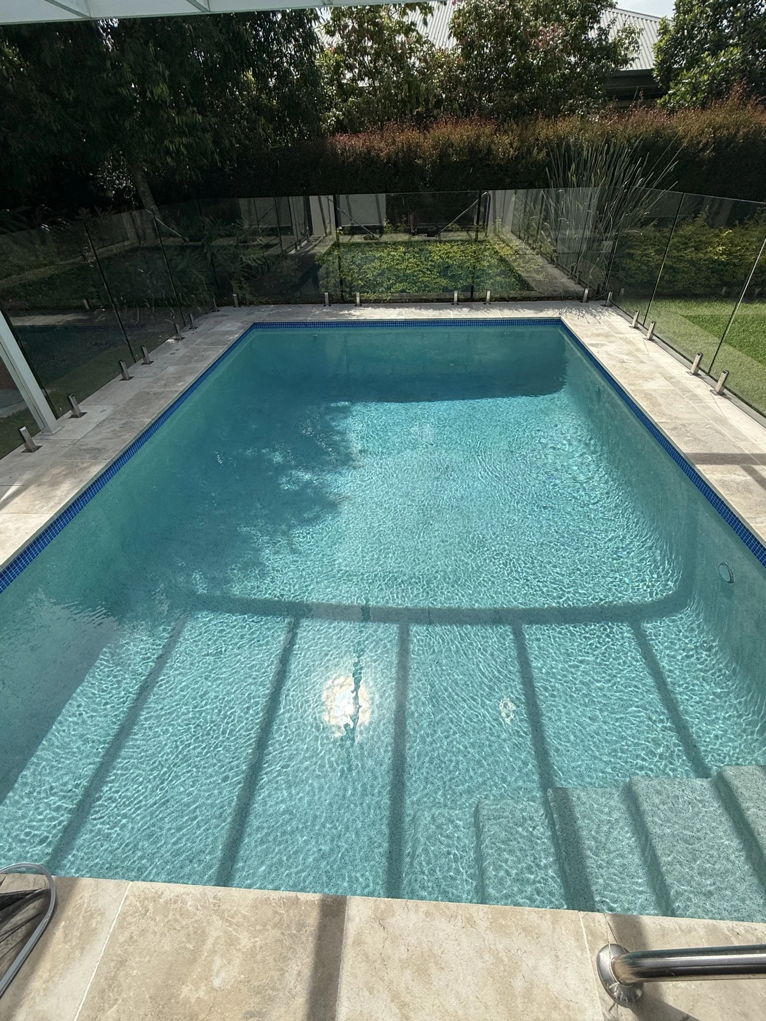 sun shining onto clean rectangular pool