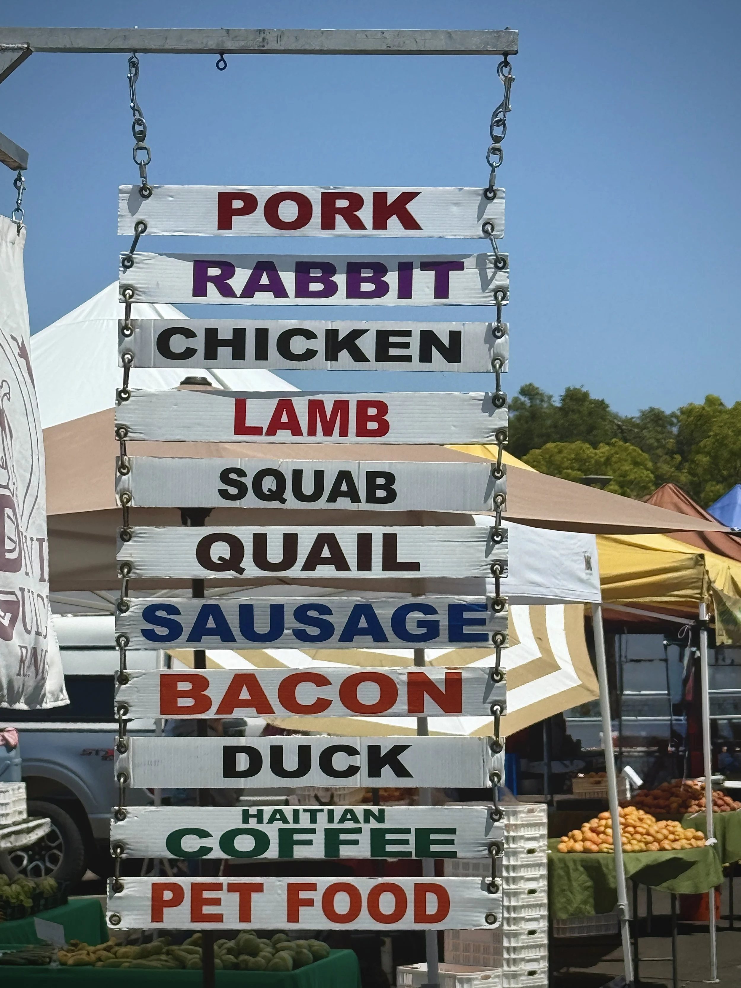 Various signs at the farmers' market in San Rafael, California