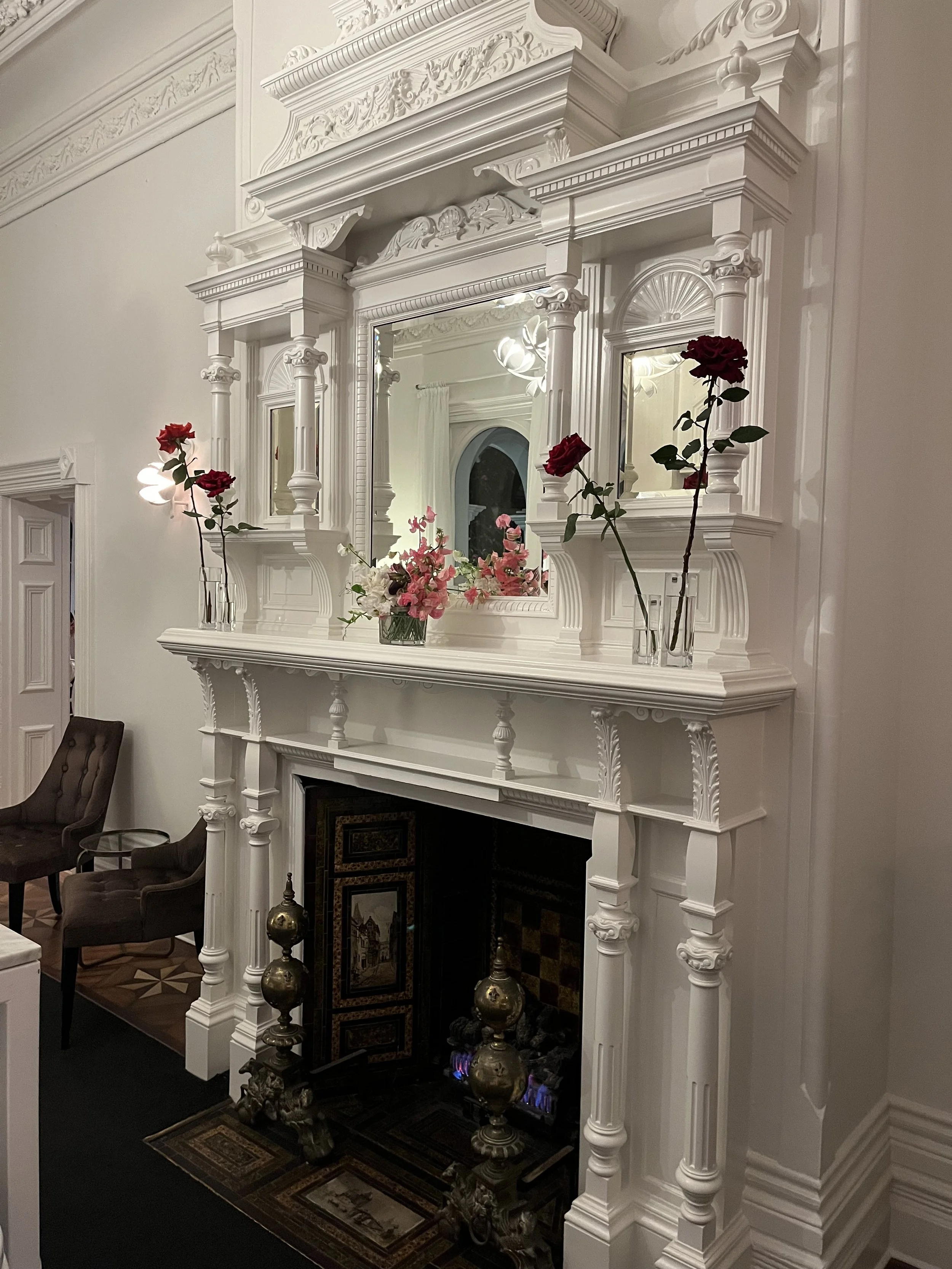 Roses, sweetpea and slipper orchids sitting elegantly on the mantle at stunning Quat Quatta