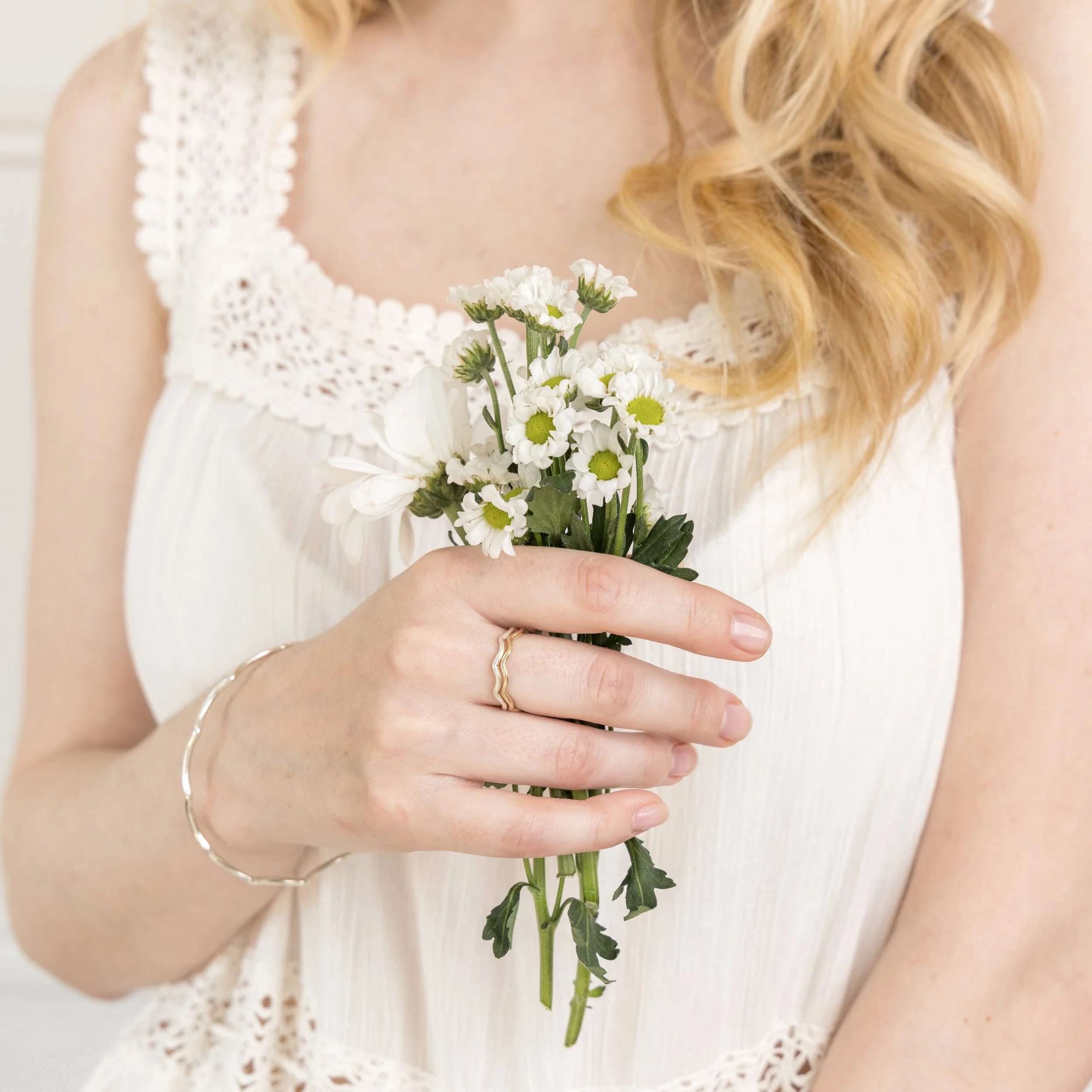 Sterling silver stacking ring with a smooth wave design and polished finish, ideal for layering in minimalist jewellery styles.