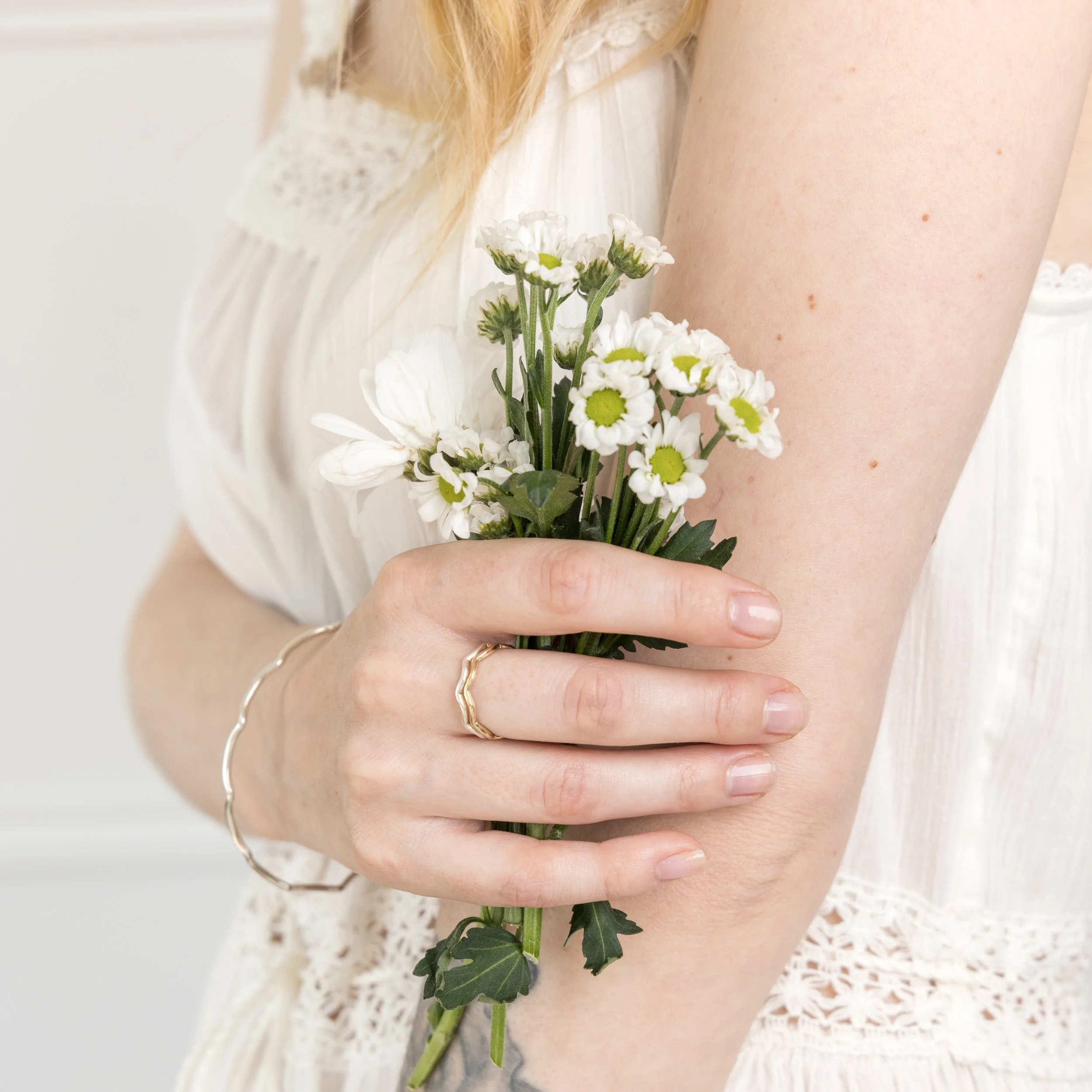 9ct yellow gold wave stacking ring with a polished curved band designed for layering or wearing solo.