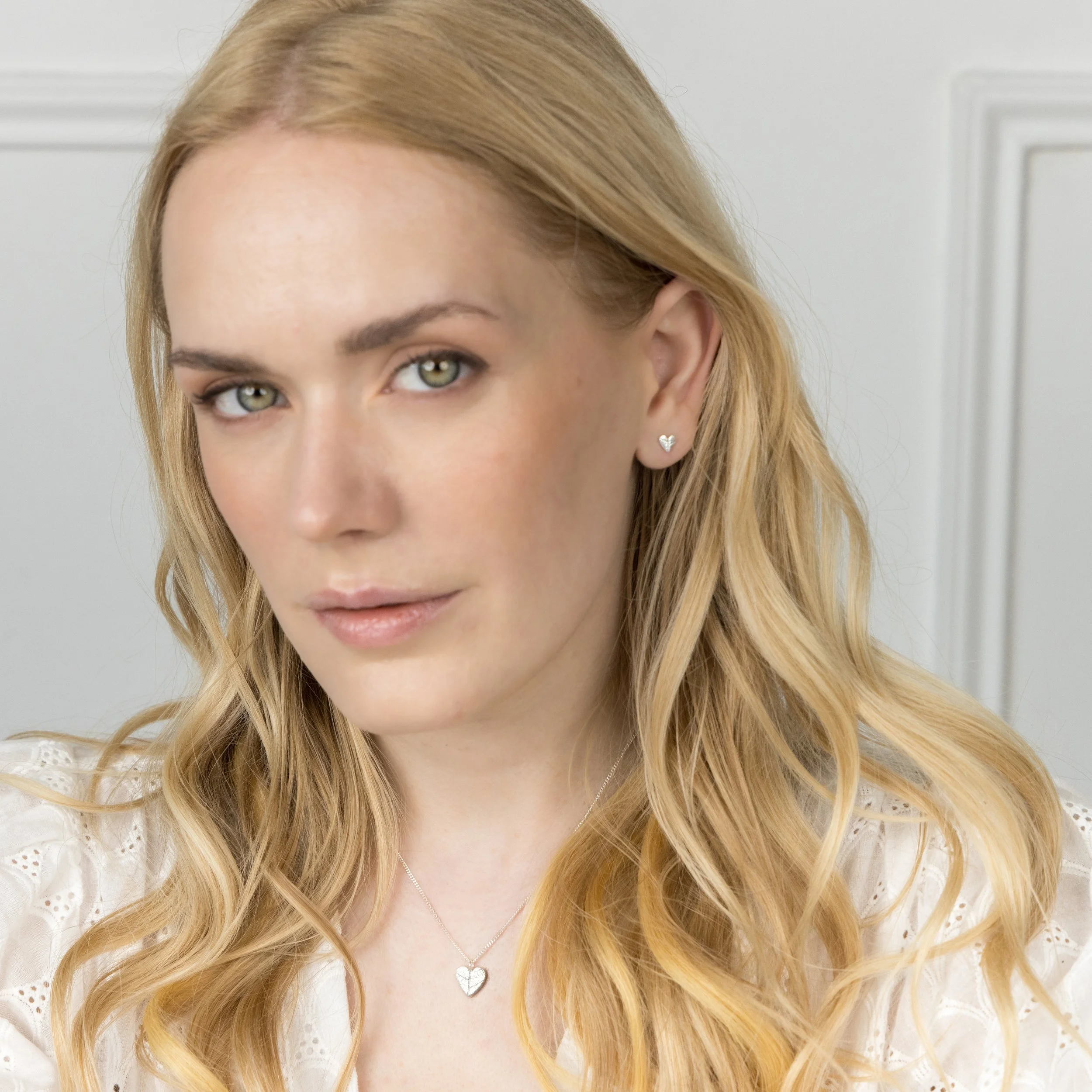 Handmade sterling silver heart pendant with delicate leaf vein texture on a fine silver chain necklace.