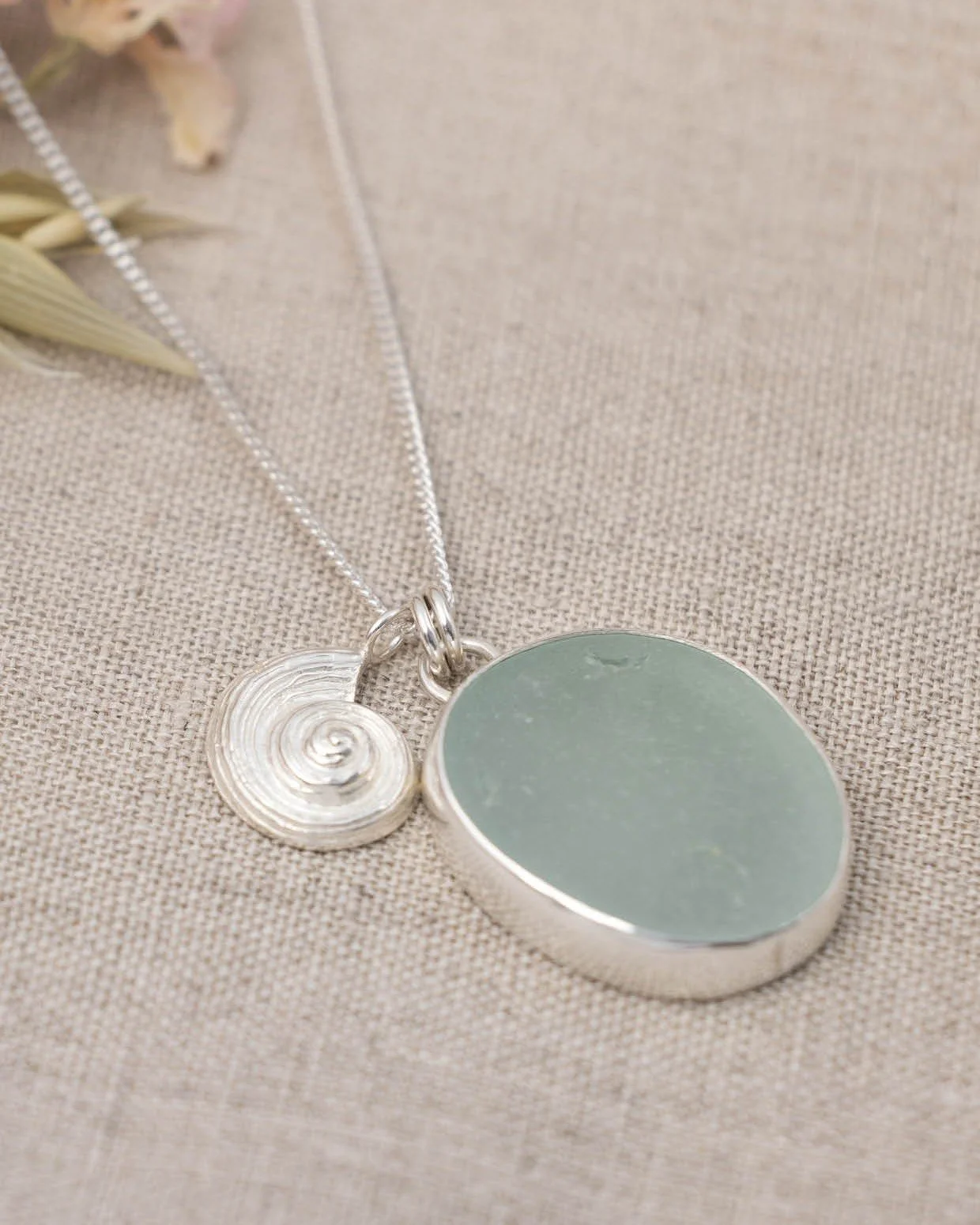 A little piece of the coast, captured in silver 🌊

Our Ammonite &amp; Sea Glass Necklace brings together a handcrafted silver ammonite with beautifully soft sea glass &mdash; two organic textures that feel as though they were always meant to sit tog