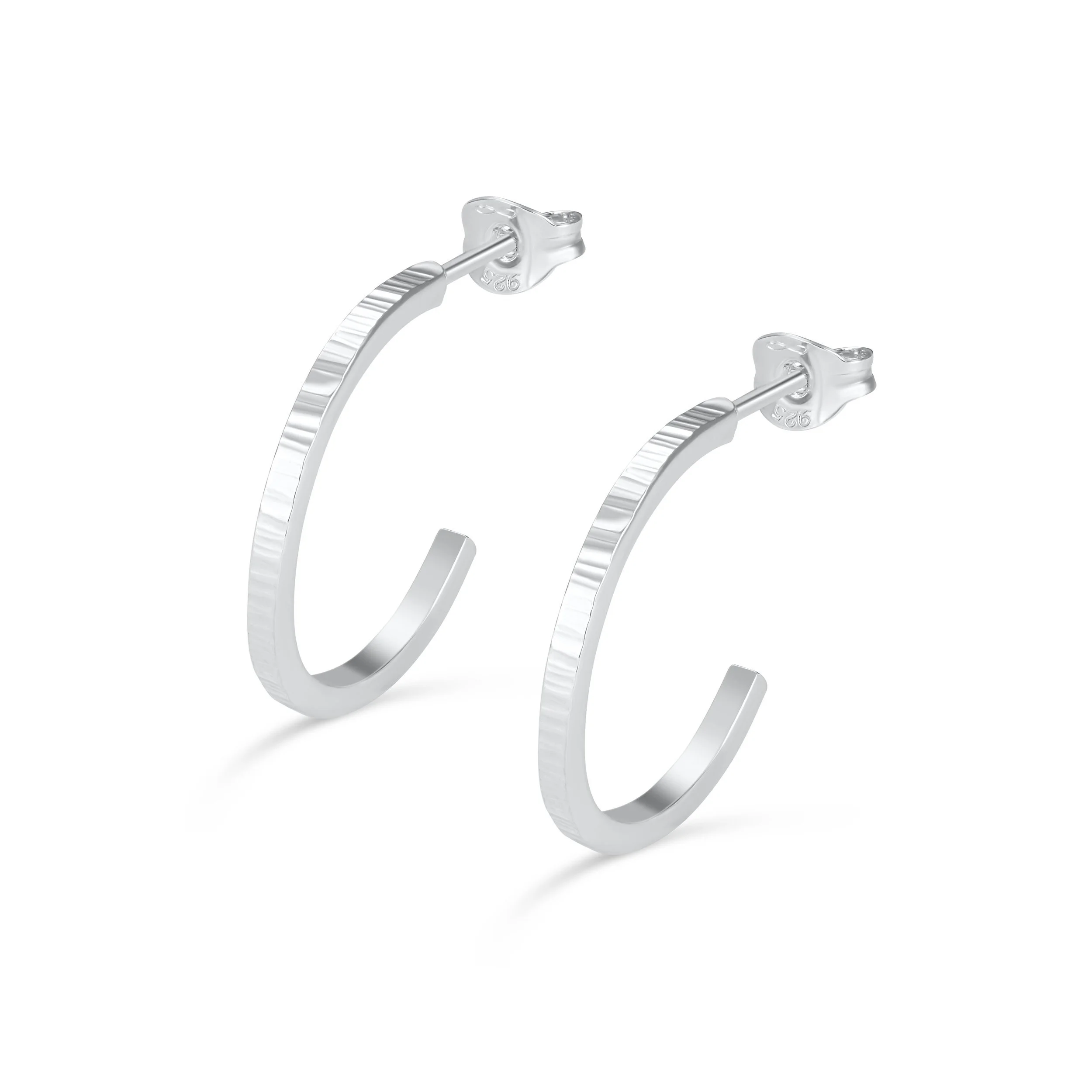 Sterling silver hoop earrings with a hammered texture, polished finish, and lightweight modern design for everyday wear.