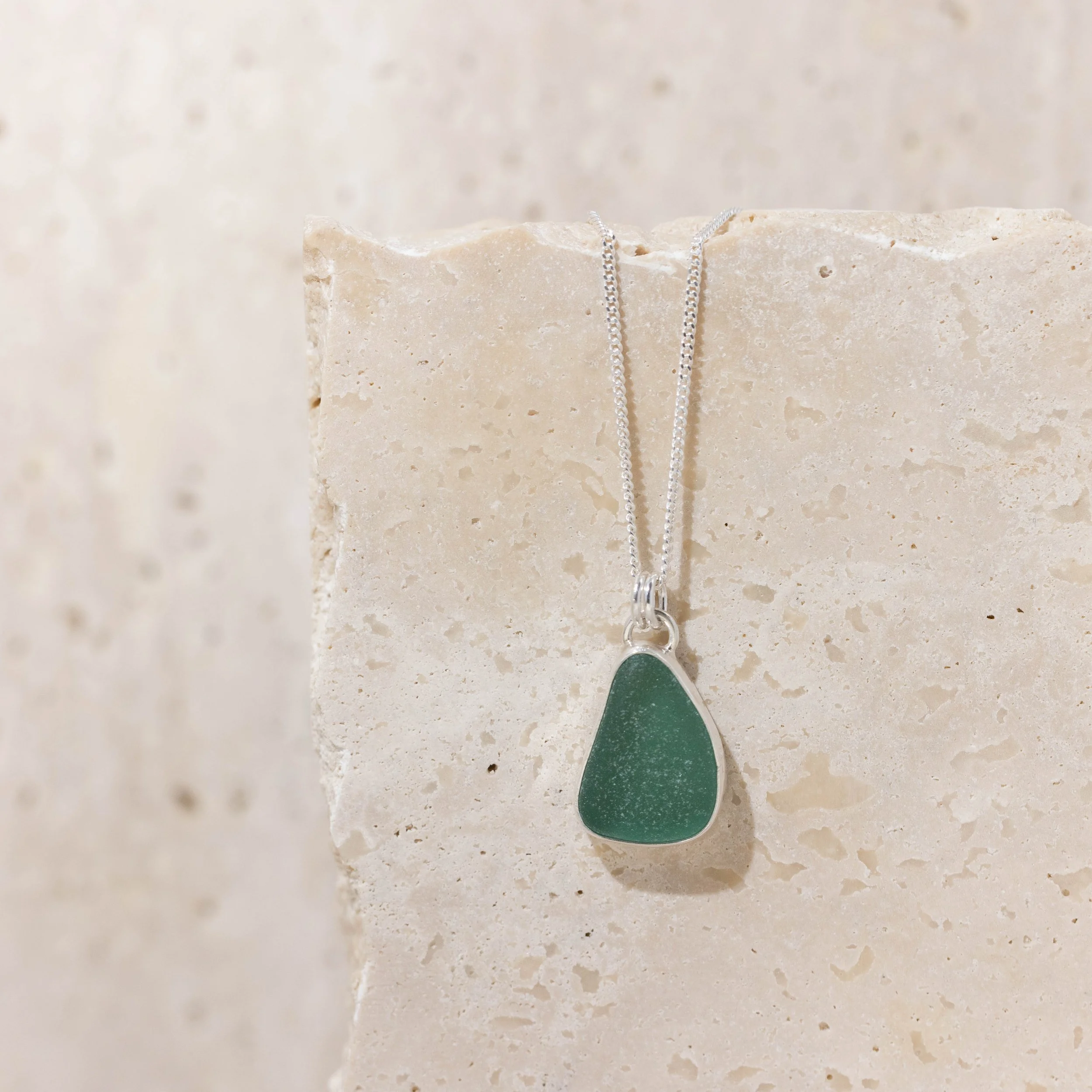 Teal sea glass pendant necklace with sterling silver bezel setting on a delicate silver chain.
