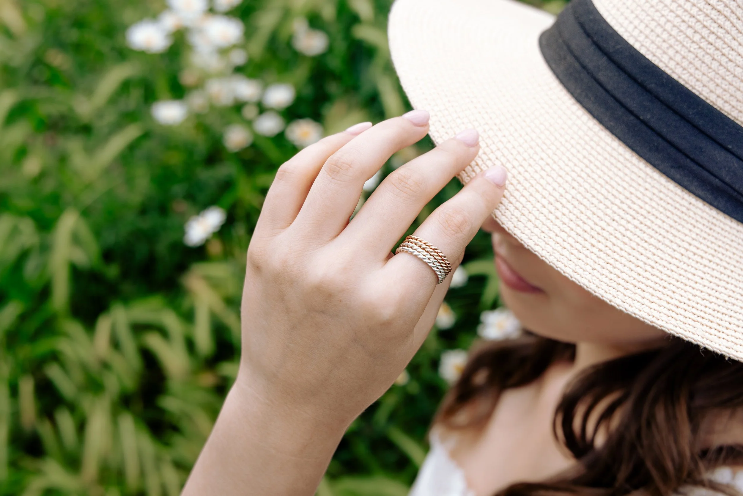 Delicate 9ct white gold twist stacking ring with a polished rope design, ideal for layering or wearing as a minimalist band.