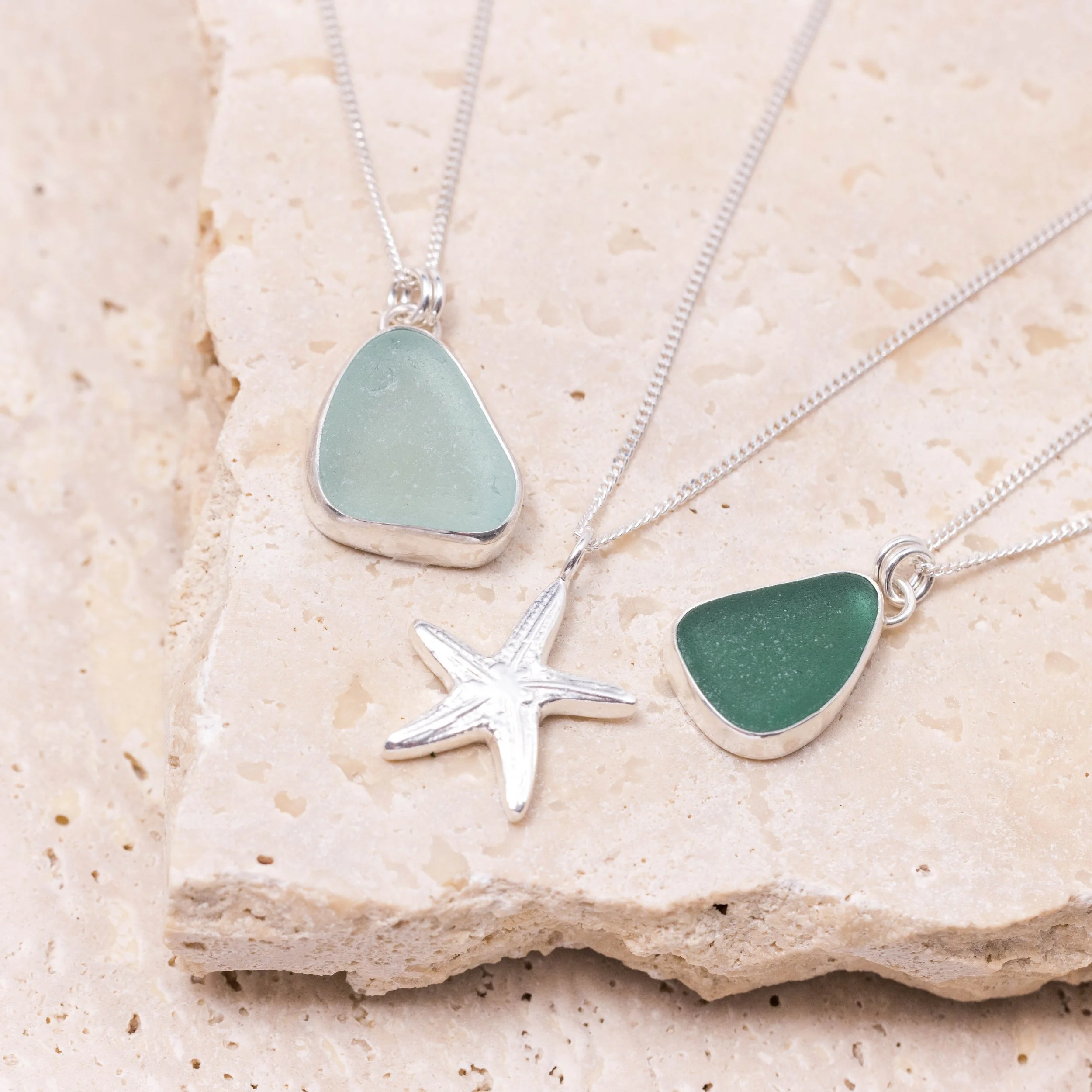 Teal sea glass pendant necklace with sterling silver bezel setting on a delicate silver chain.