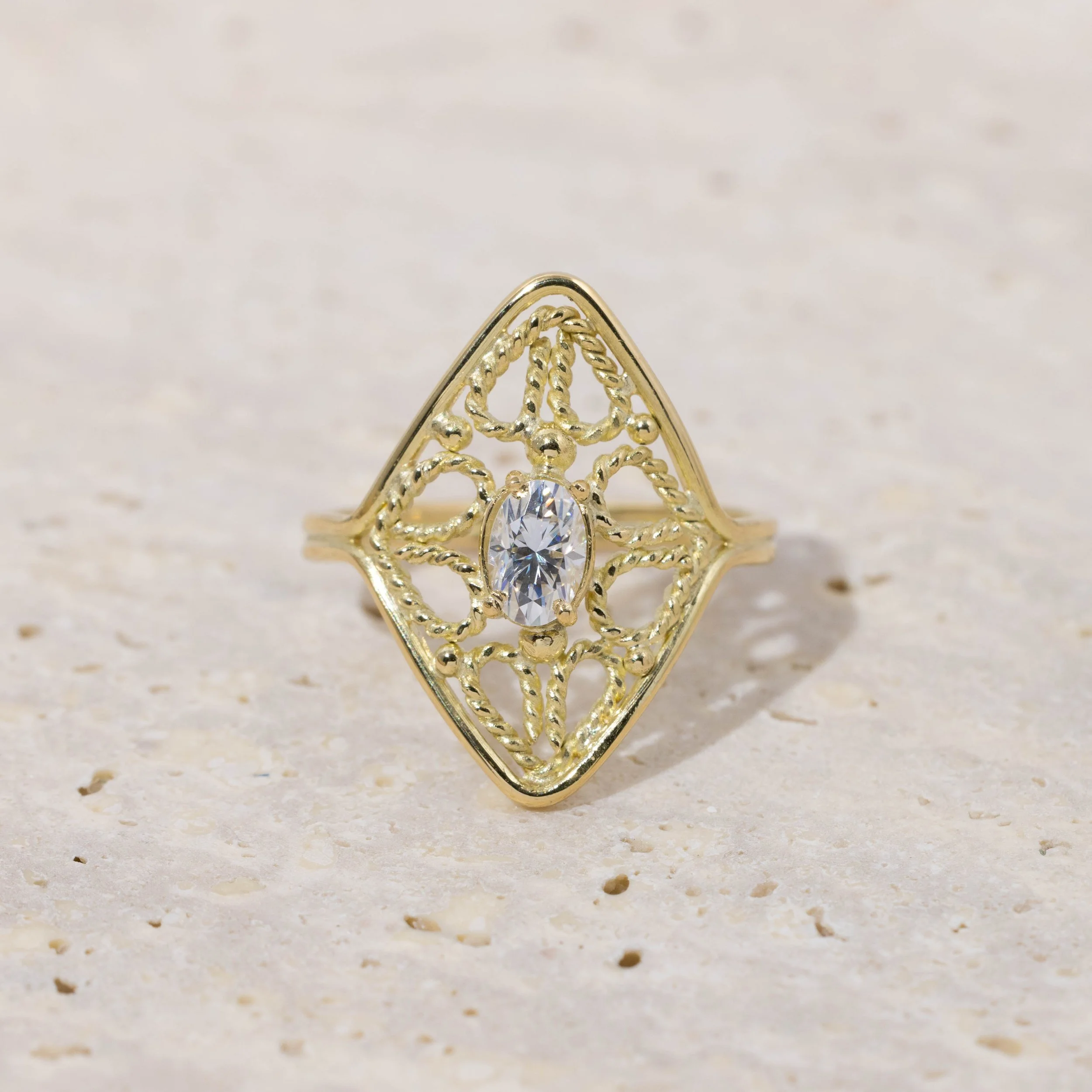 18ct yellow gold filigree ring with oval brilliant-cut moissanite centre stone and intricate vintage-inspired detailing.