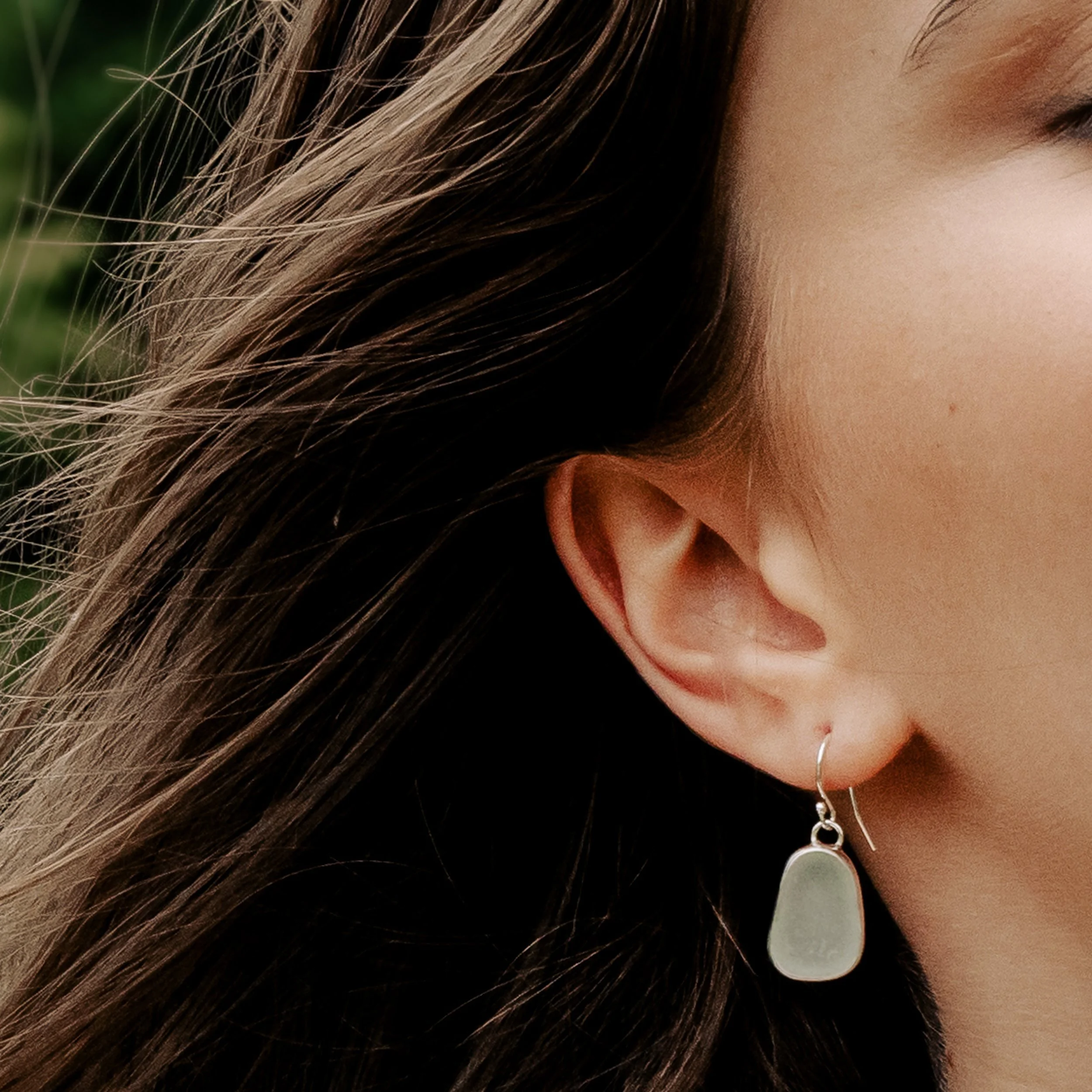 Sterling silver drop earrings with smooth aqua sea glass pebbles and minimalist ear wires, coastal inspired jewellery design.