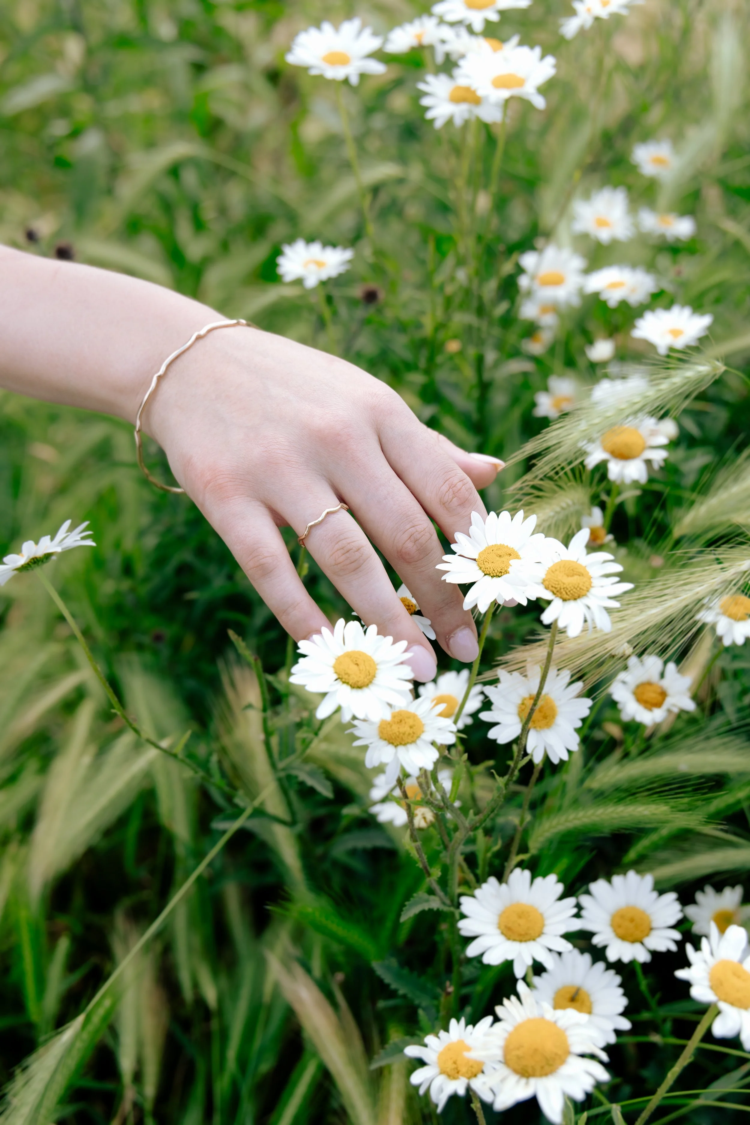 9ct yellow gold wave stacking ring with a polished curved band designed for layering or wearing solo.