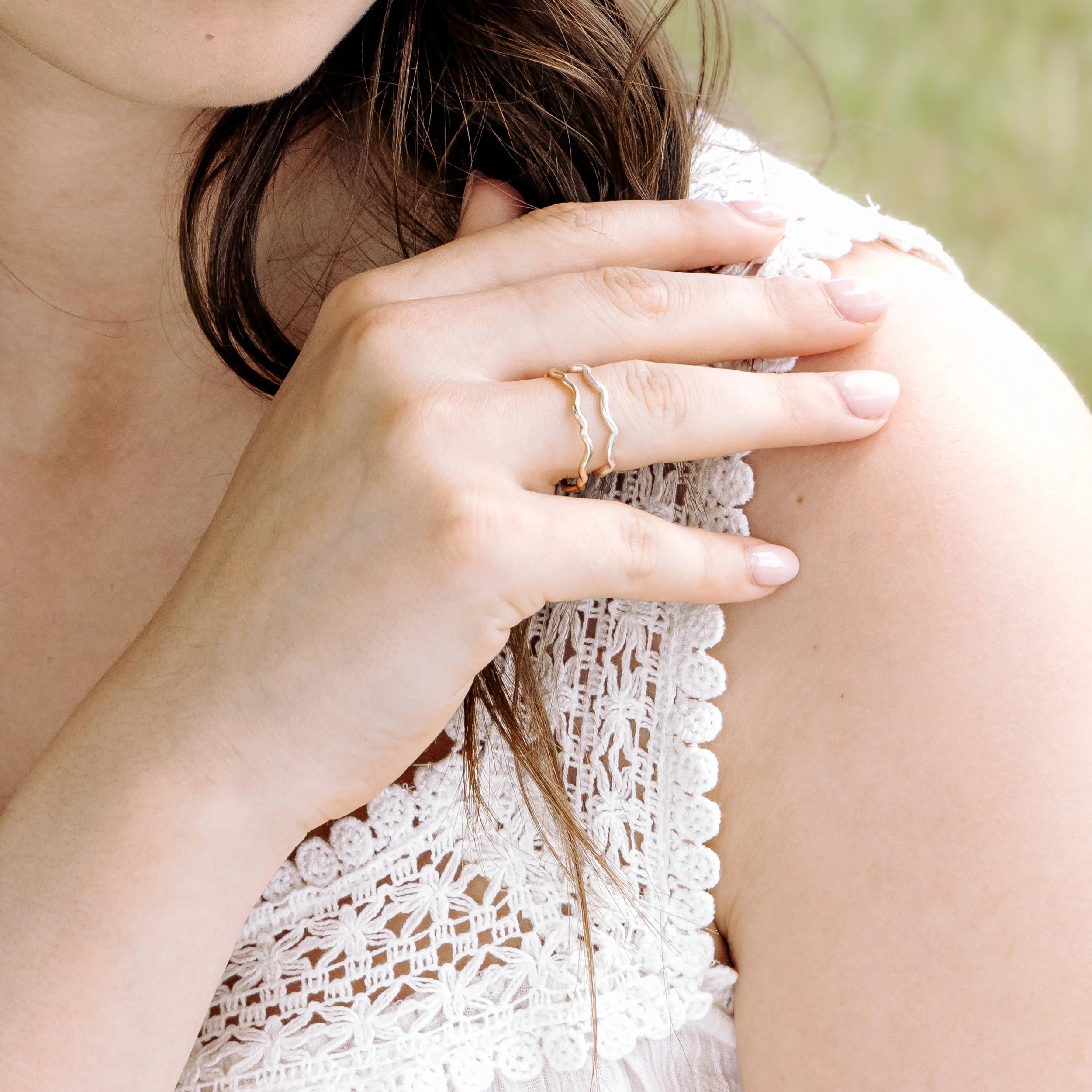 Sterling silver stacking ring with a smooth wave design and polished finish, ideal for layering in minimalist jewellery styles.