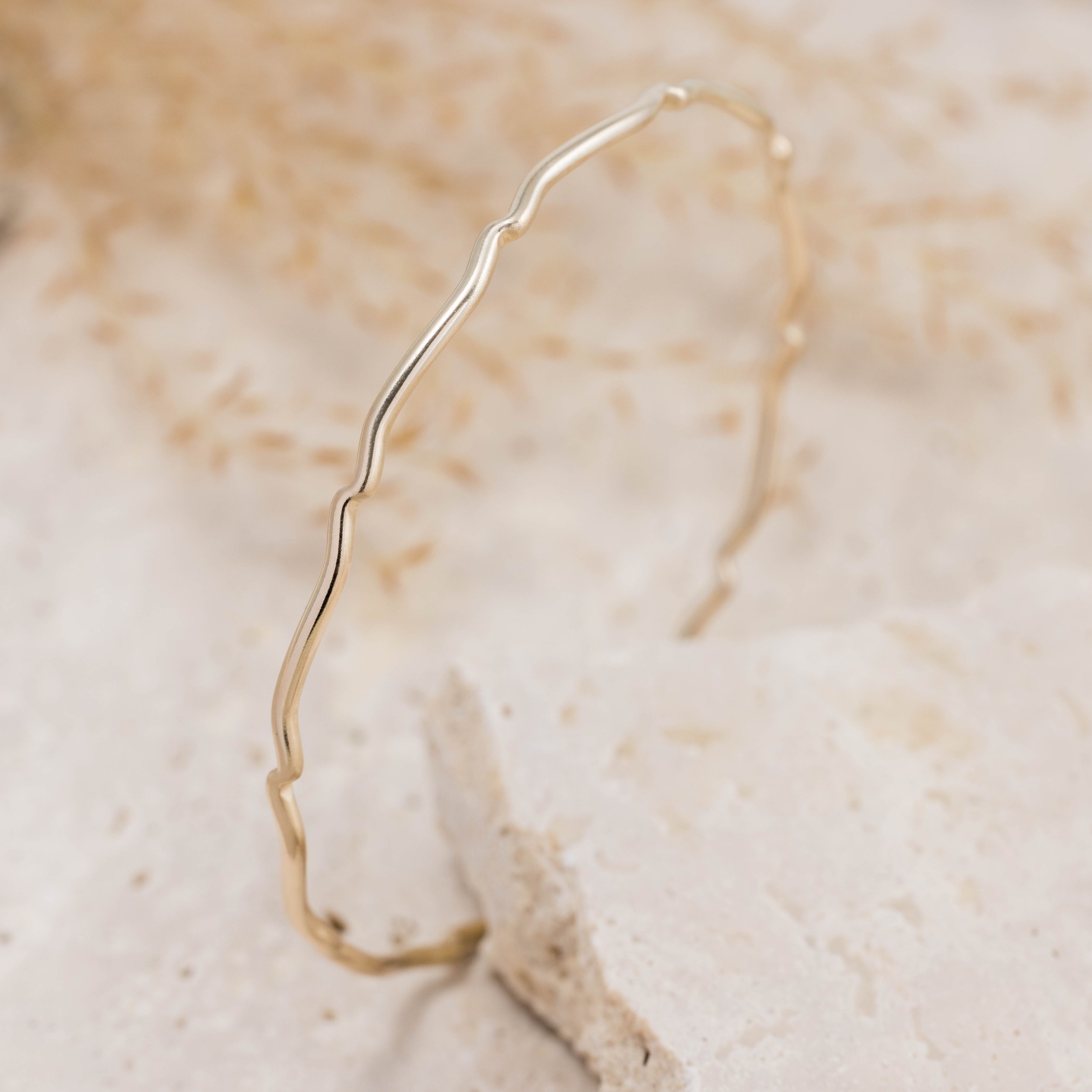 9ct yellow gold scallop bangle with a smooth polished finish and subtle scalloped edge, designed for elegant stacking and everyday wear.