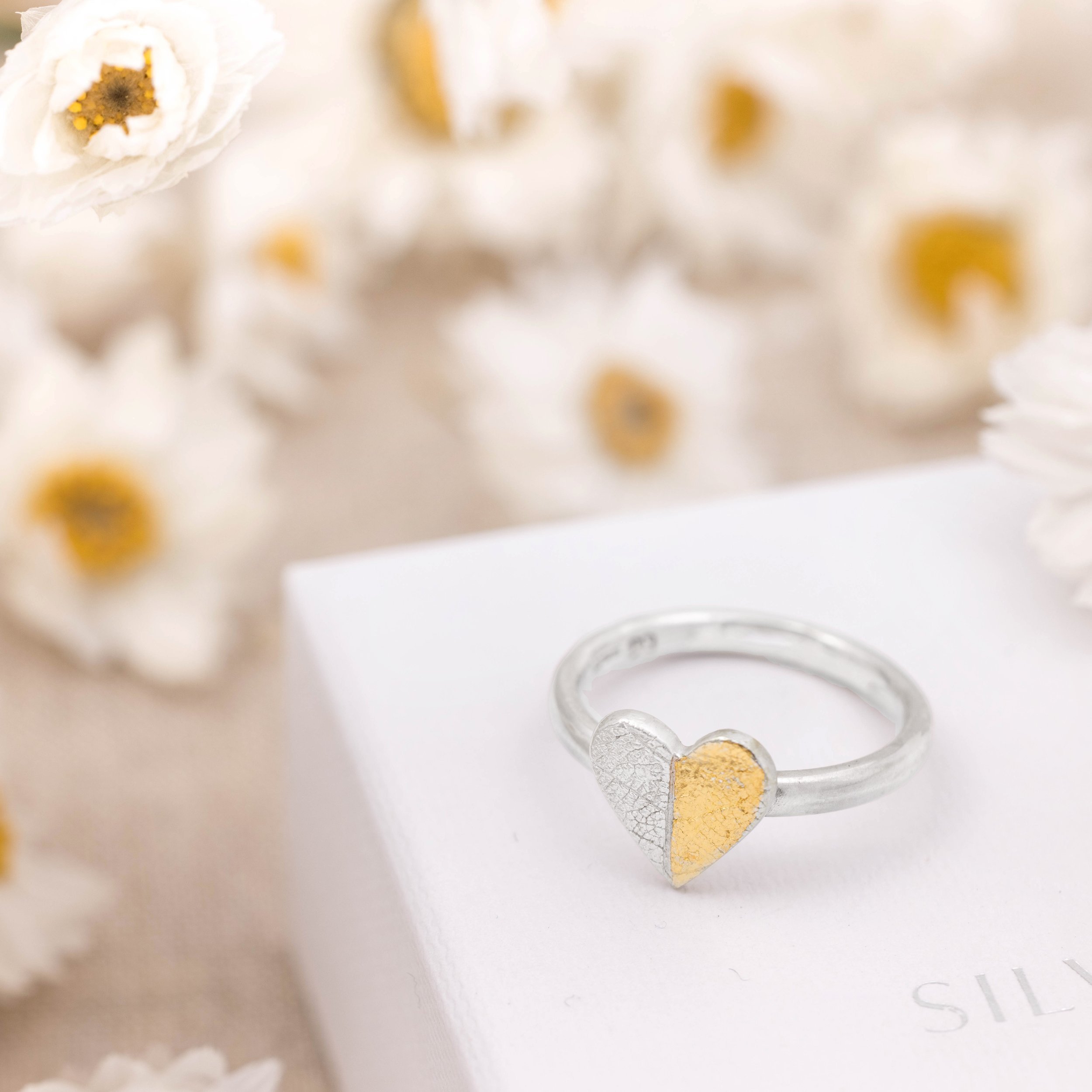 Sterling silver heart-shaped ring with textured leaf pattern and 24ct gold Keum Boo detailing on a polished band.