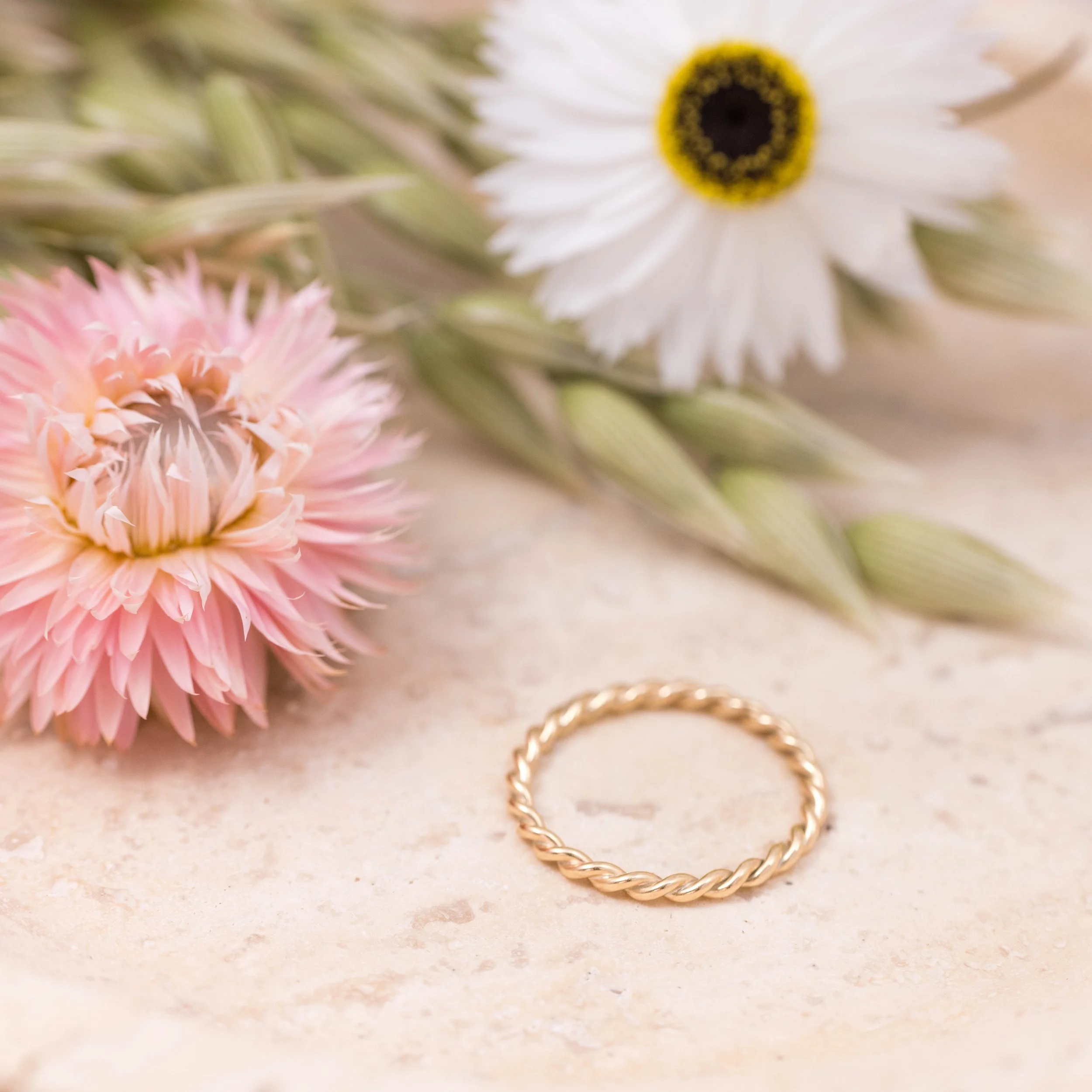 Delicate 9ct yellow gold twist stacking ring with a polished rope design, perfect for layering or wearing as a minimalist band.