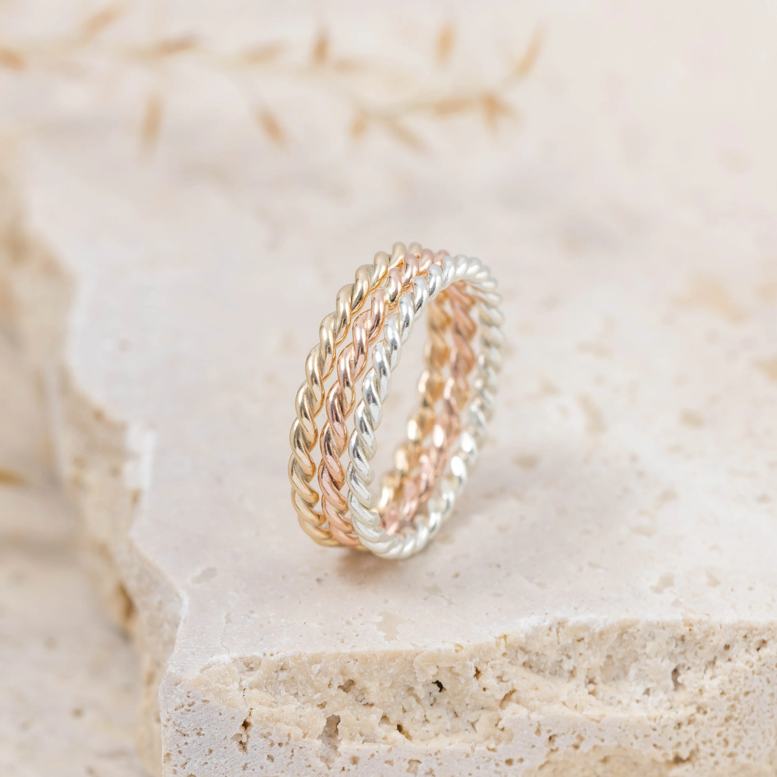 Delicate 9ct yellow gold twist stacking ring with a polished rope design, perfect for layering or wearing as a minimalist band.