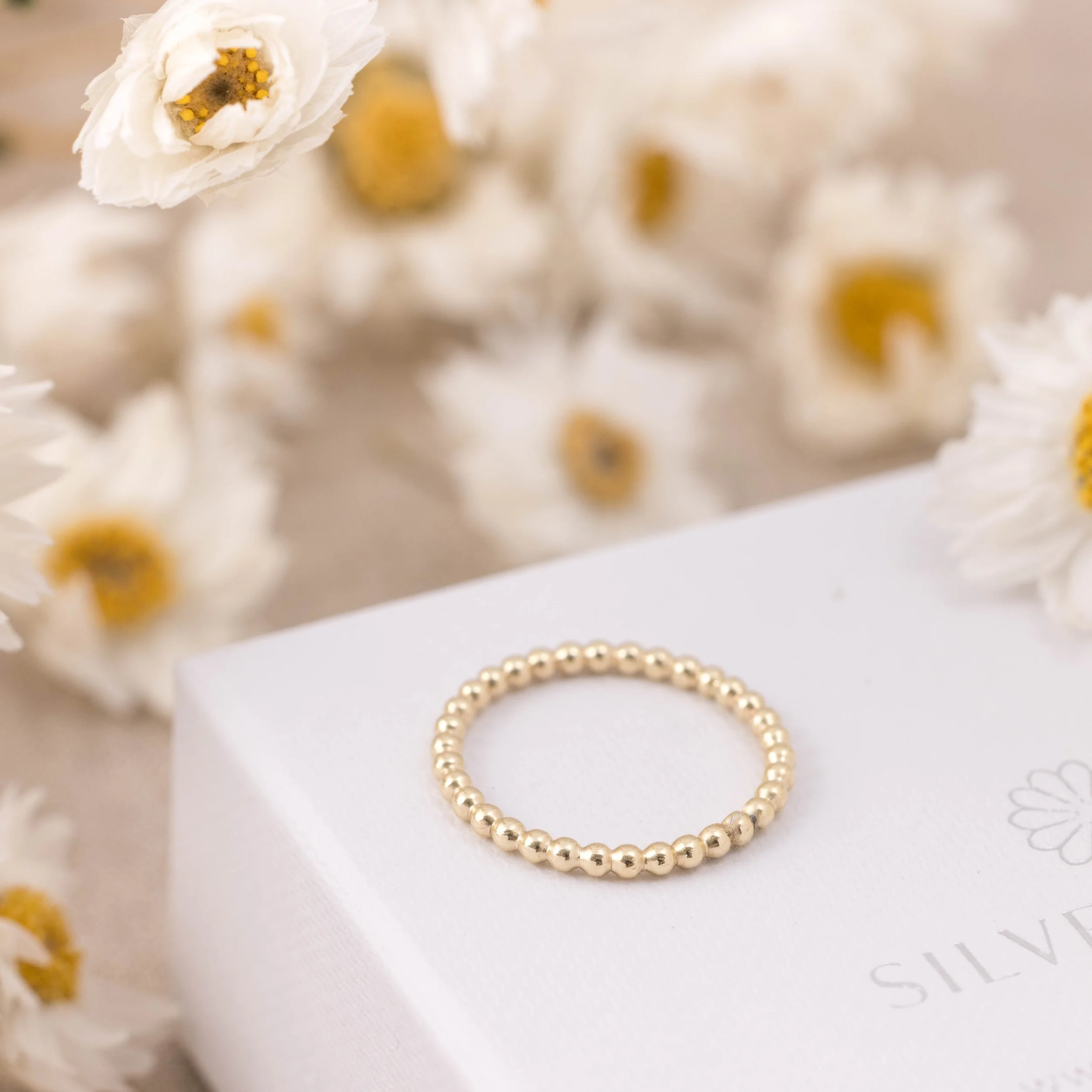 9ct yellow gold stacking ring with a delicate bobble design, featuring a polished finish and slender band for versatile wear.
