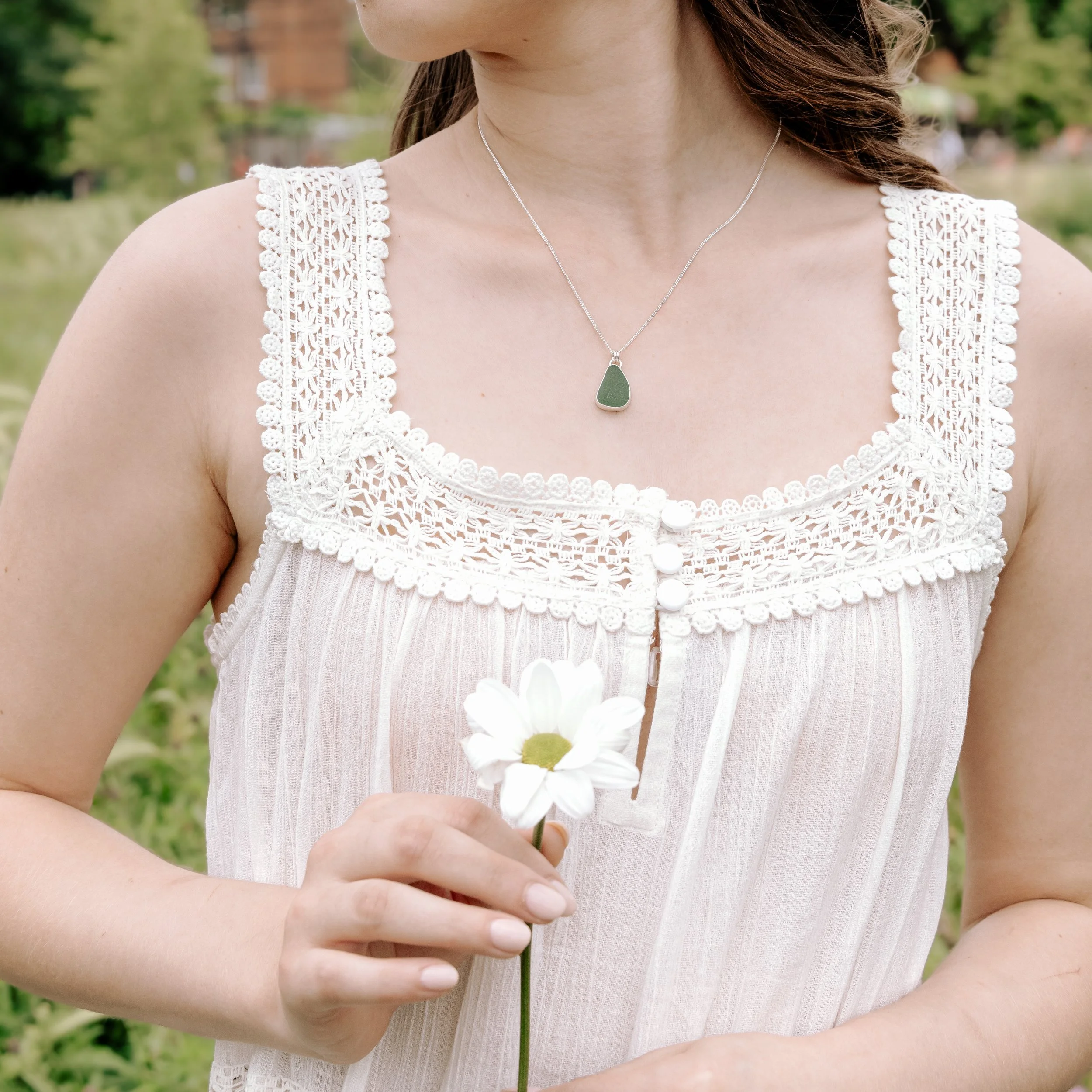 Teal sea glass pendant necklace with sterling silver bezel setting on a delicate silver chain.