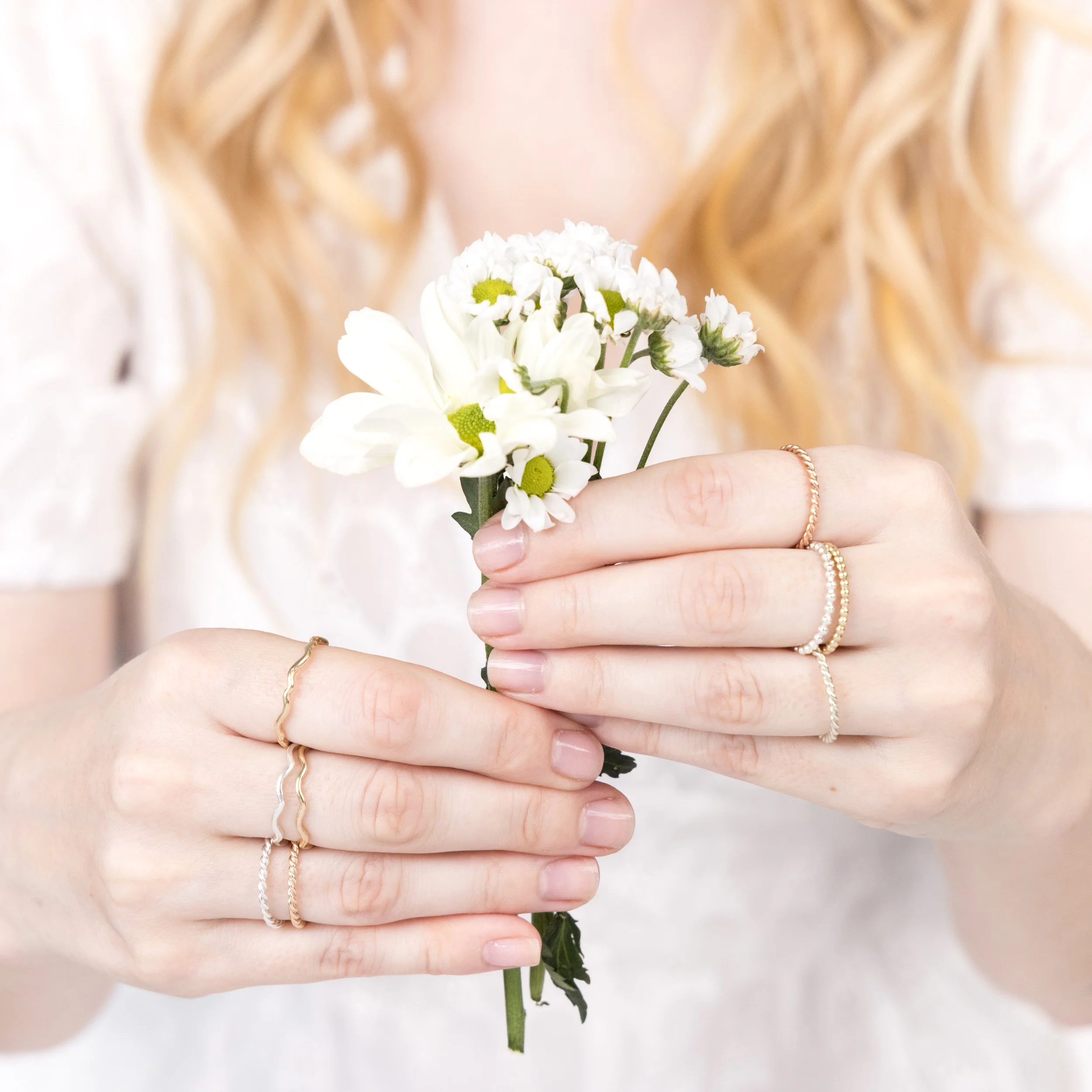 Polished sterling silver twist stacking ring with a delicate rope design, ideal for layering or wearing alone.