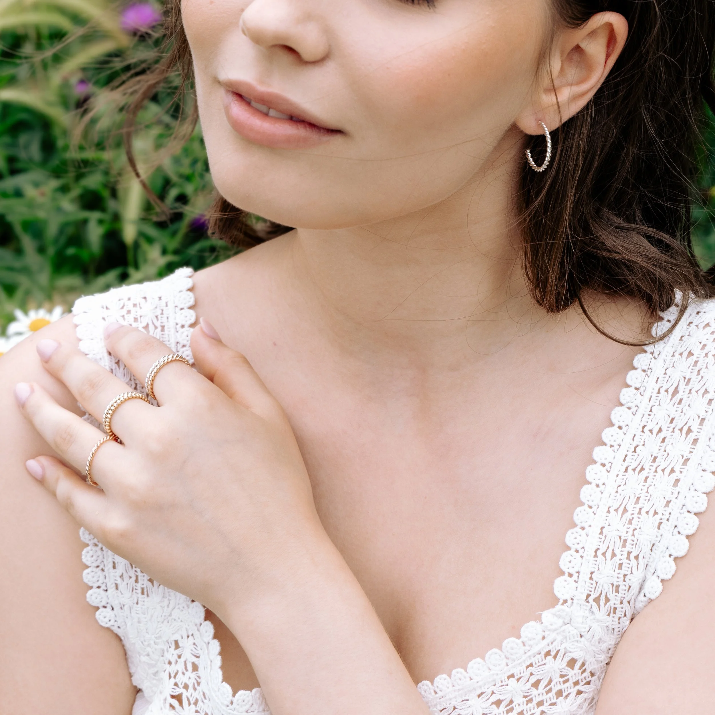 Polished sterling silver twist hoop earrings with a textured spiral design, lightweight and elegant for everyday wear.
