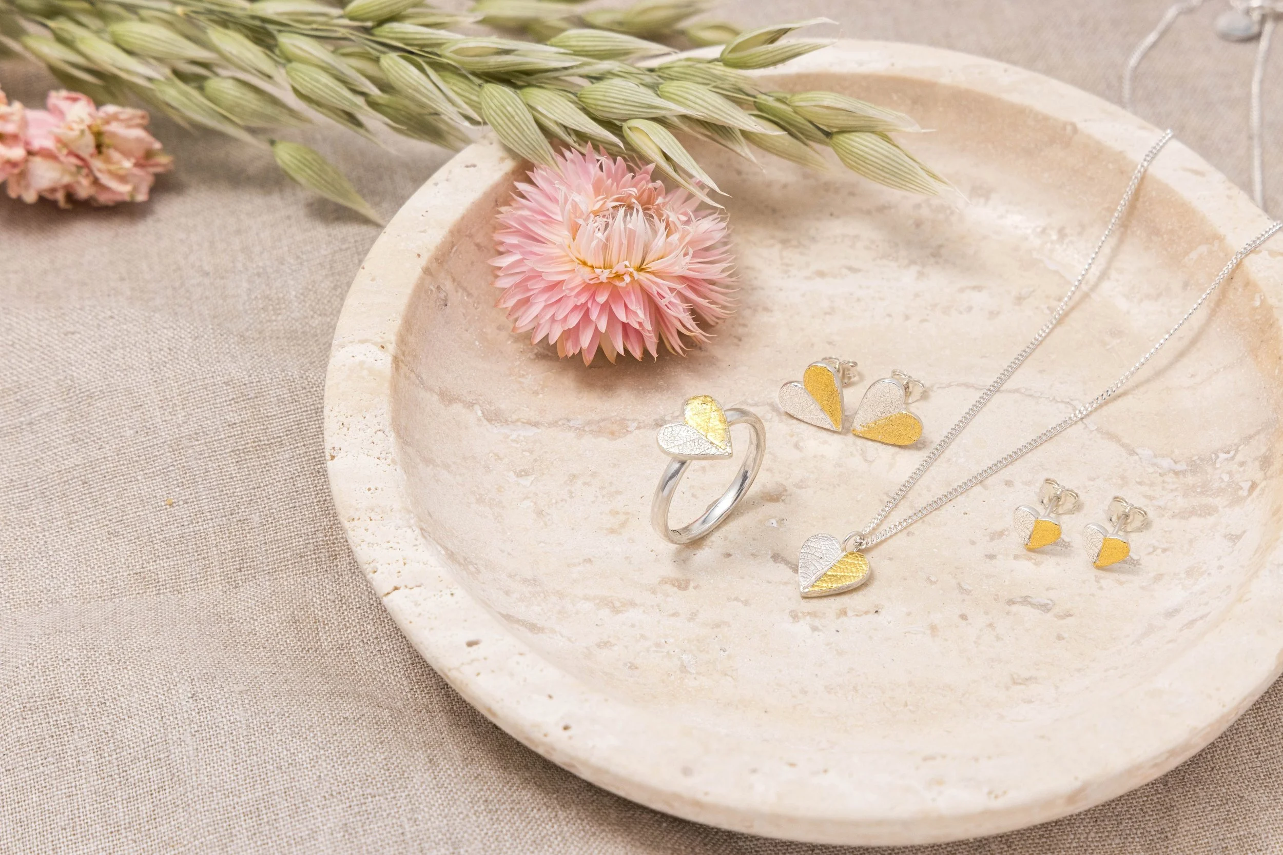 Sterling silver heart-shaped ring with textured leaf pattern and 24ct gold Keum Boo detailing on a polished band.