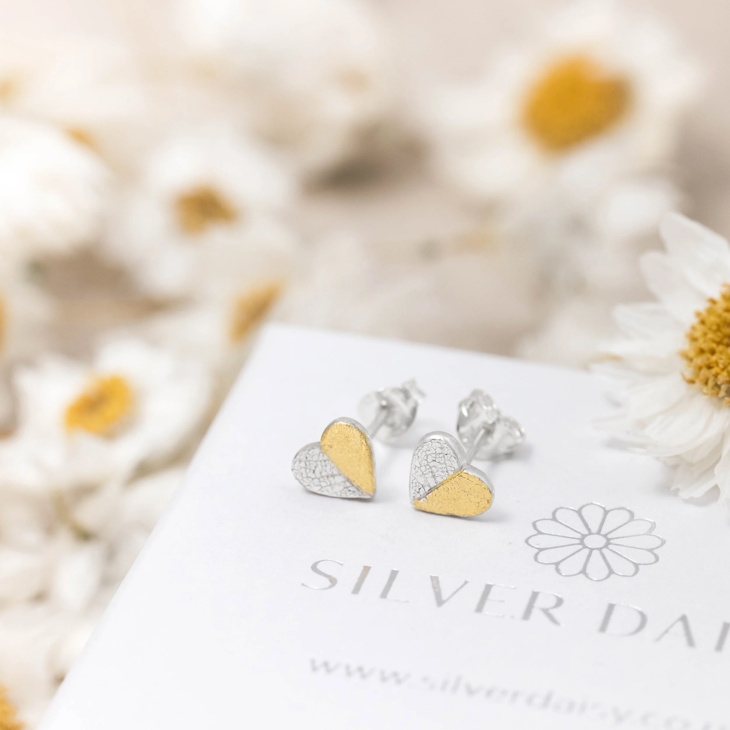Mini sterling silver heart stud earrings with delicate leaf print texture and 24ct gold keum-boo accents.