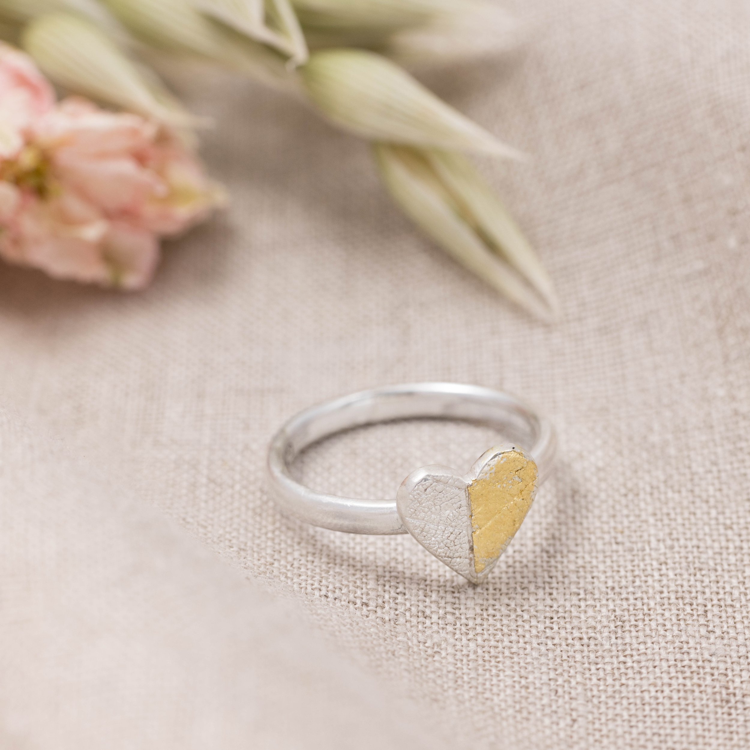 Sterling silver heart-shaped ring with textured leaf pattern and 24ct gold Keum Boo detailing on a polished band.