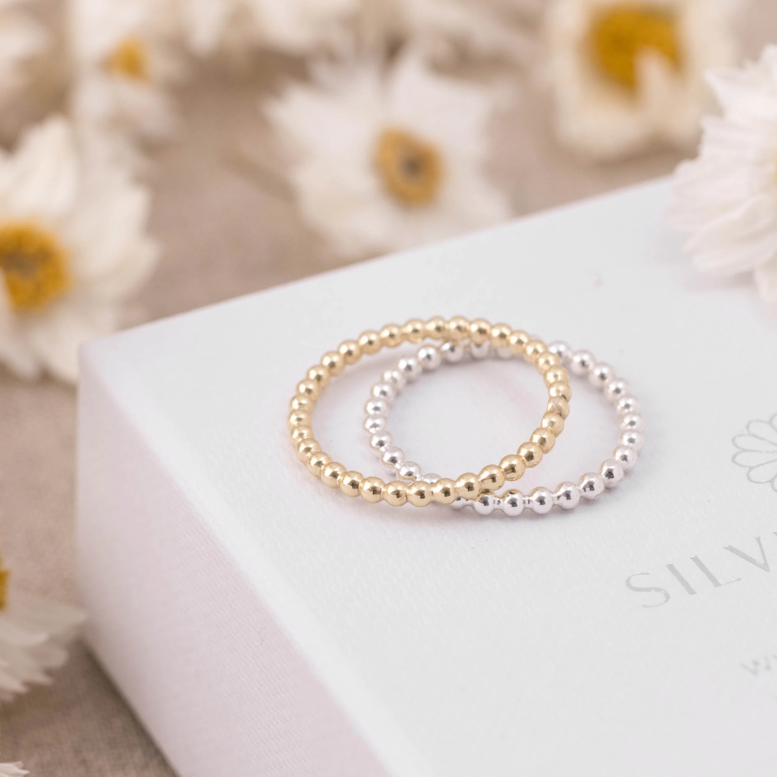 Sterling silver bobble stacking ring with polished beaded band, minimalist design ideal for layering or everyday wear.