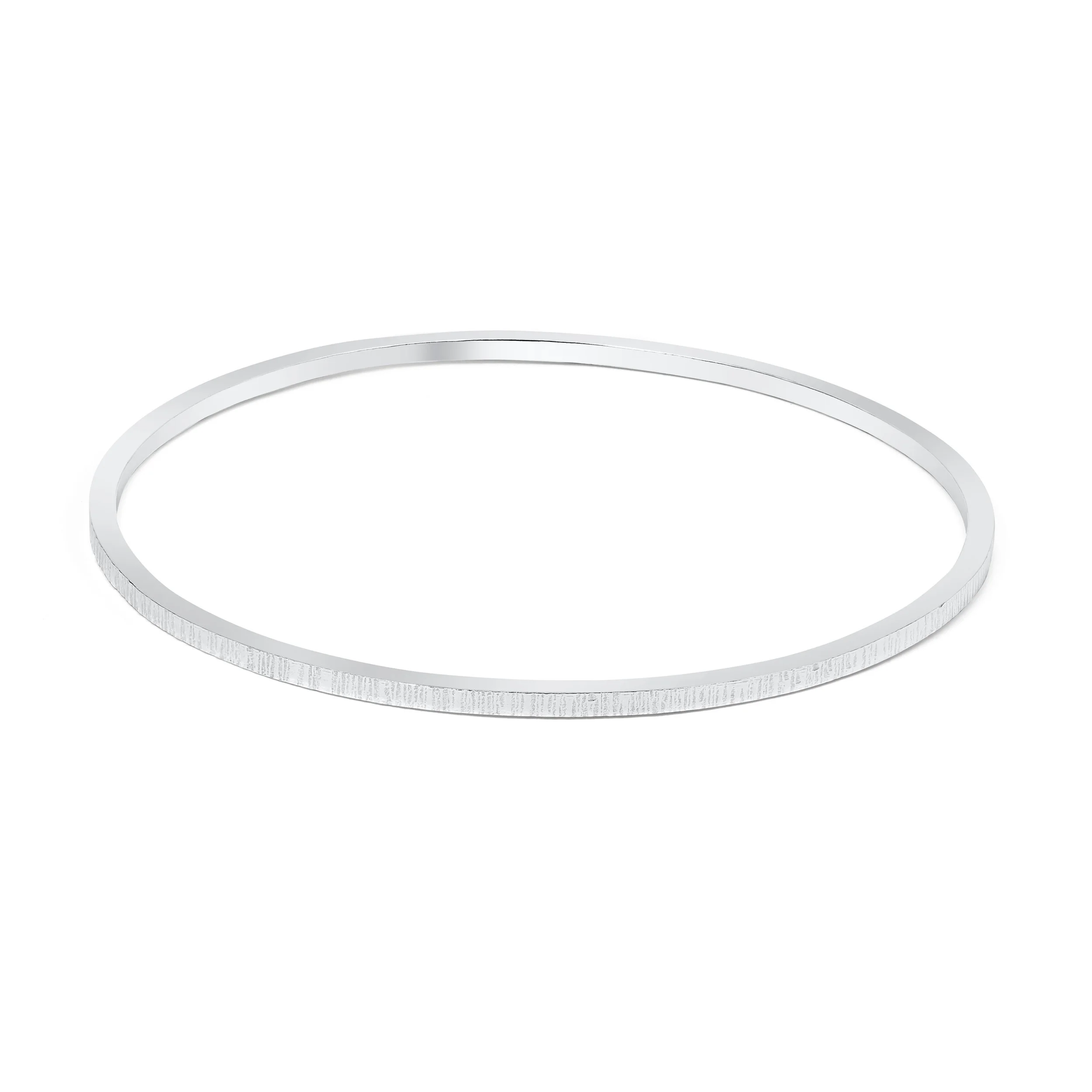 Slim sterling silver stacking bangle with a hammered line texture, polished finish, and minimalist contemporary design.