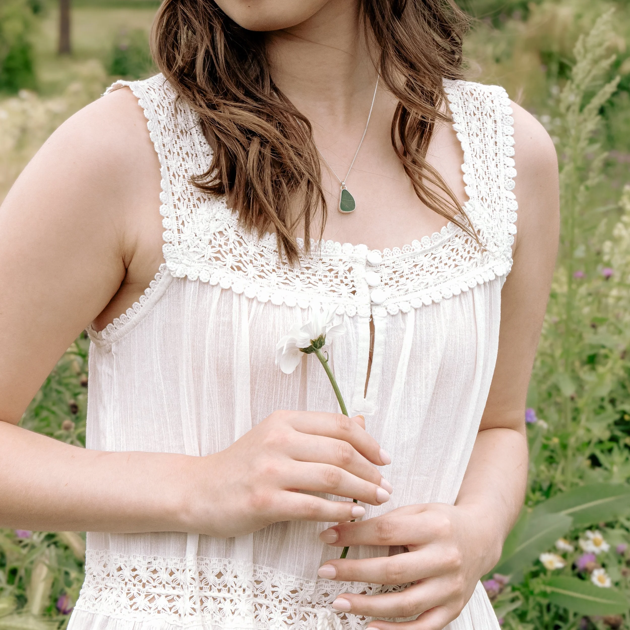 Teal sea glass pendant necklace with sterling silver bezel setting on a delicate silver chain.