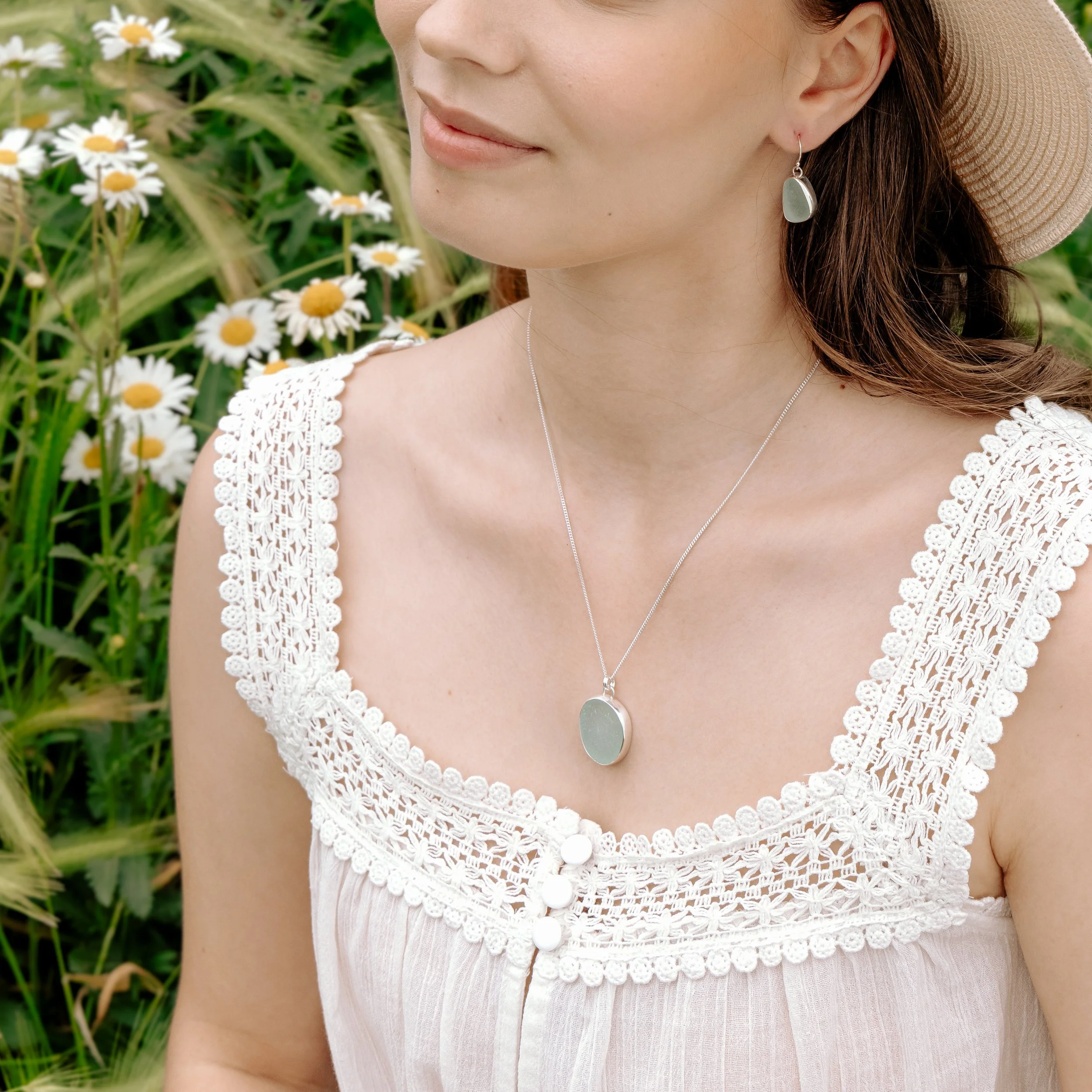 Aqua sea glass pebble set in polished silver on a delicate chain, coastal-inspired handmade necklace.