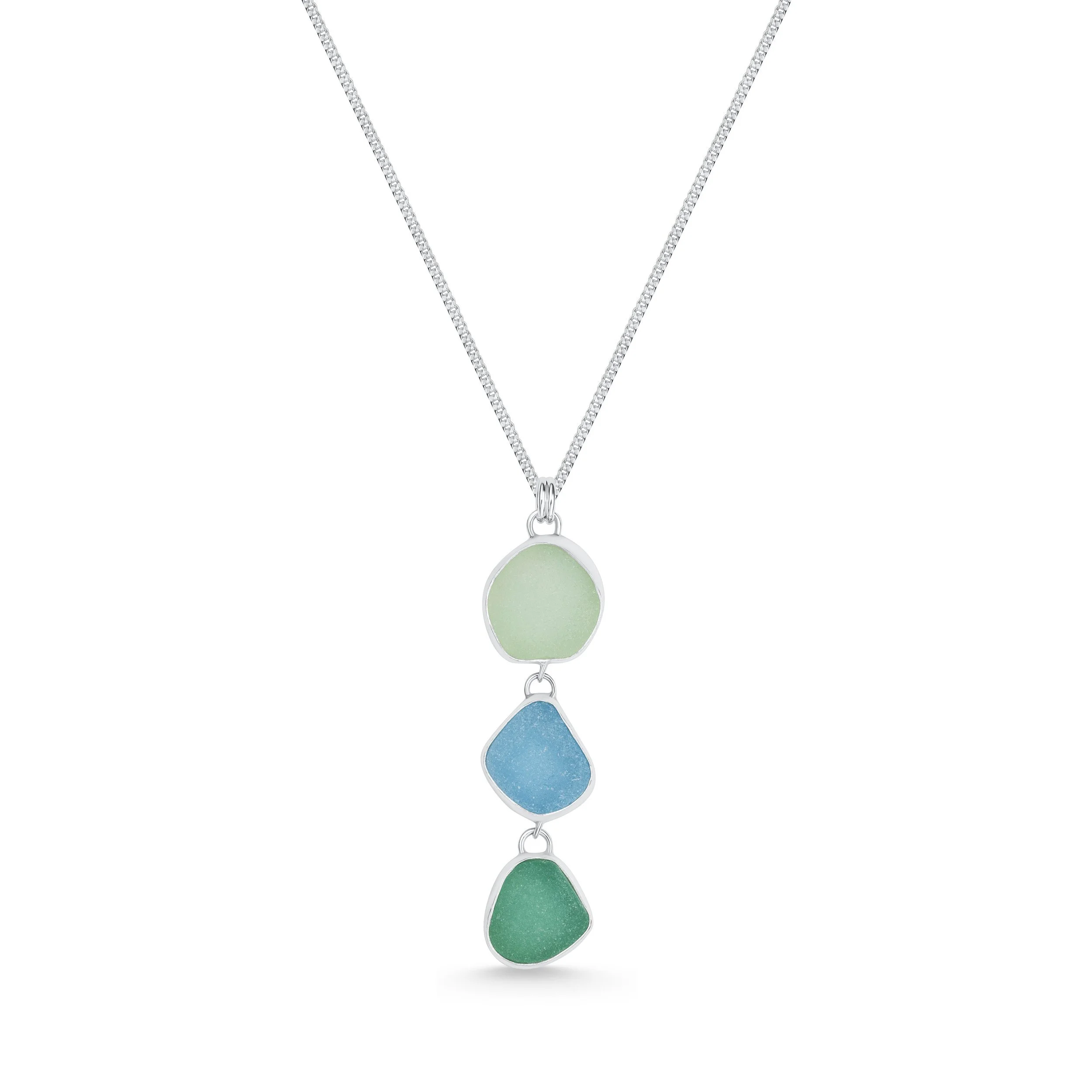 Sterling silver pendant necklace with cascading multi-coloured sea glass drops in green and blue tones, inspired by coastal style.