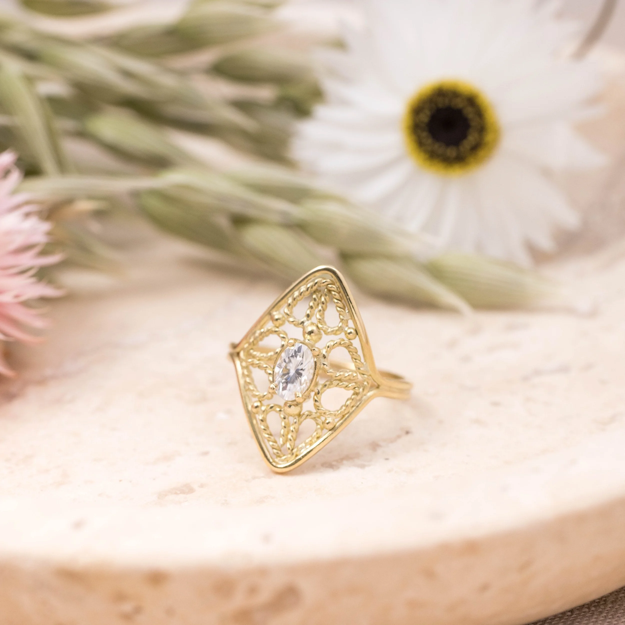 18ct yellow gold filigree ring with oval brilliant-cut moissanite centre stone and intricate vintage-inspired detailing.