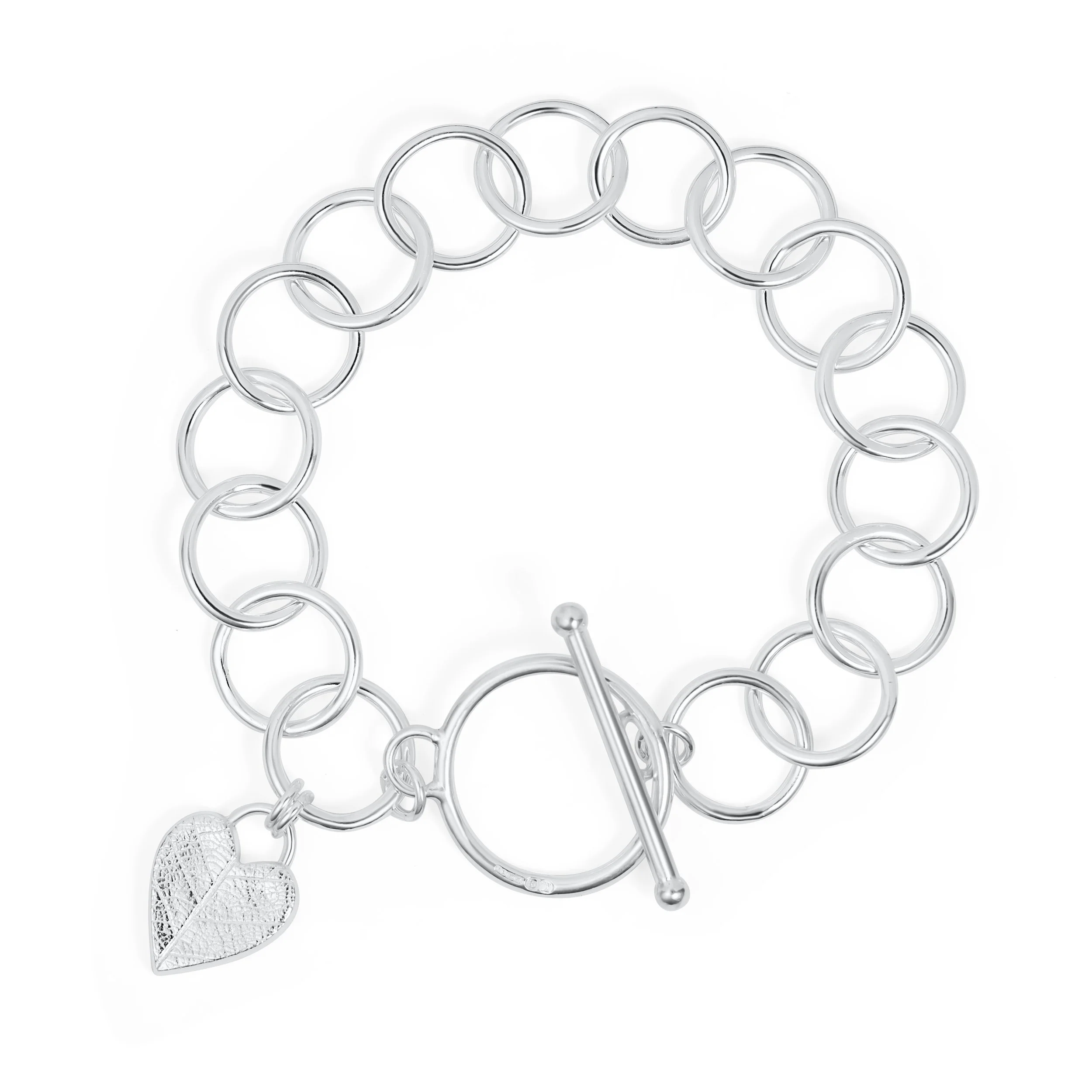 Sterling silver bracelet with a textured heart charm featuring a delicate leaf pattern, finished with a toggle clasp.