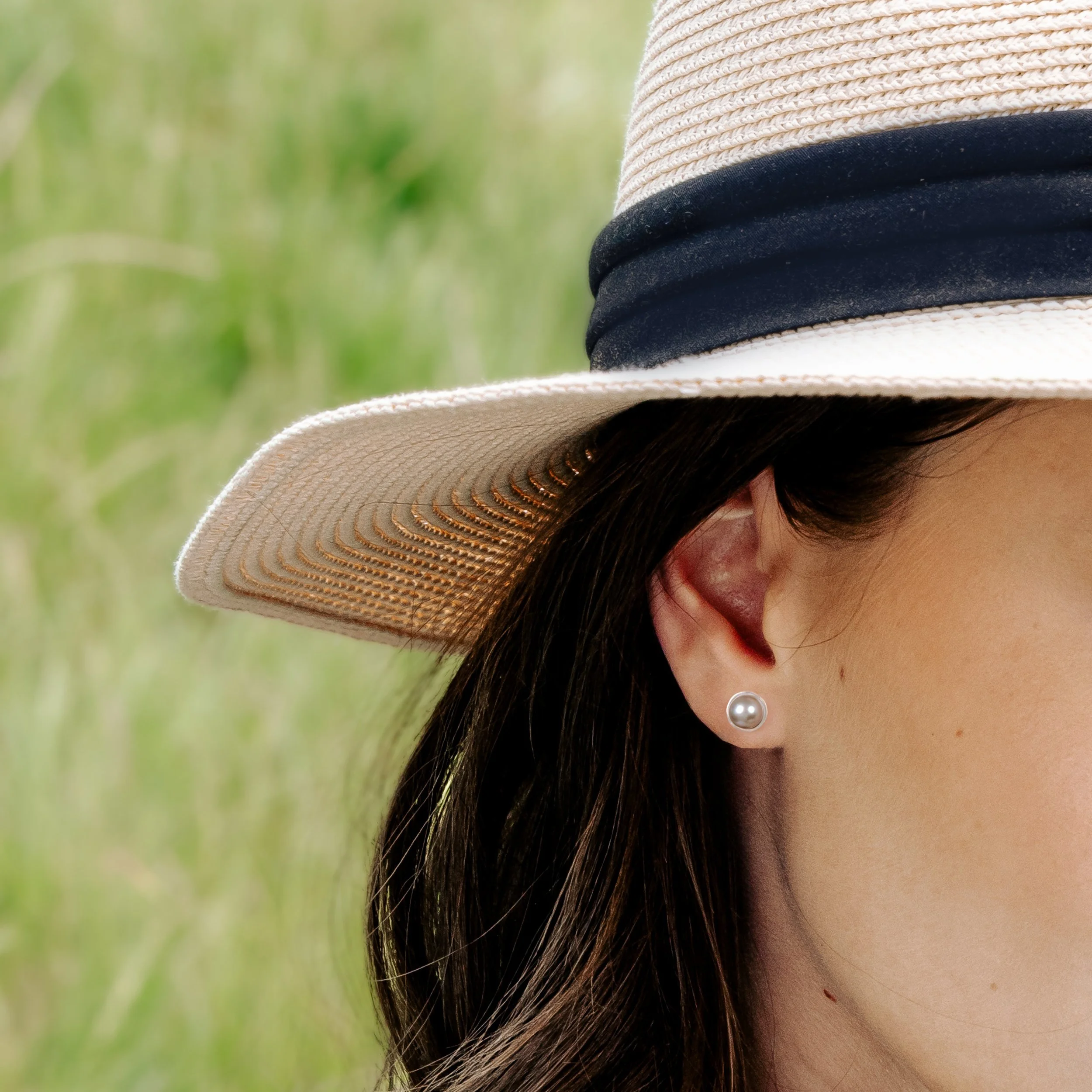 Round grey pearl stud earrings with smooth lustrous finish, set in handcrafted sterling silver cups finished with ear posts and scrolls.
