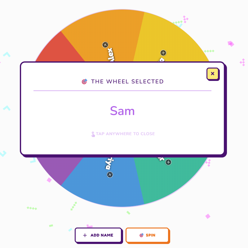 A colorful wheel with sections labeled with different names, and a pop-up in the center stating 'The Wheel Selected' with the name 'Sam'.