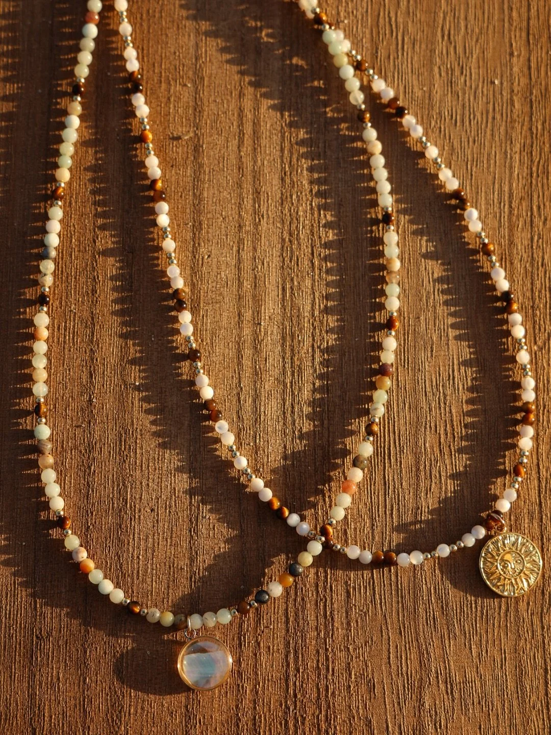 Our Kai &amp; Isla Necklaces 🤍 
💧 Kai (&ldquo;sea&rdquo;) &mdash; hues of pale blues meet earthy tones.
🌴 Isla (&ldquo;island&rdquo;) &mdash; sunlit neutrals with pearl &amp; gold accents