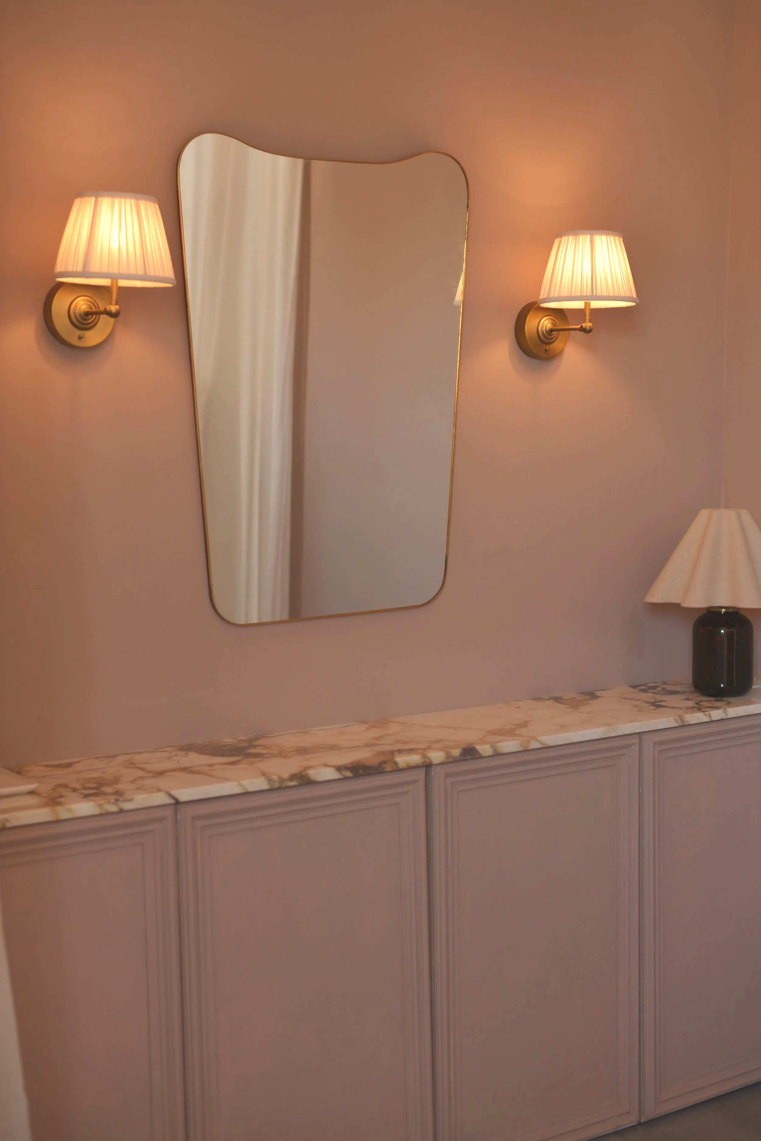 The vanity in our changing room - calcatta viola marble, linen wall lights and a mid century brass mirror
