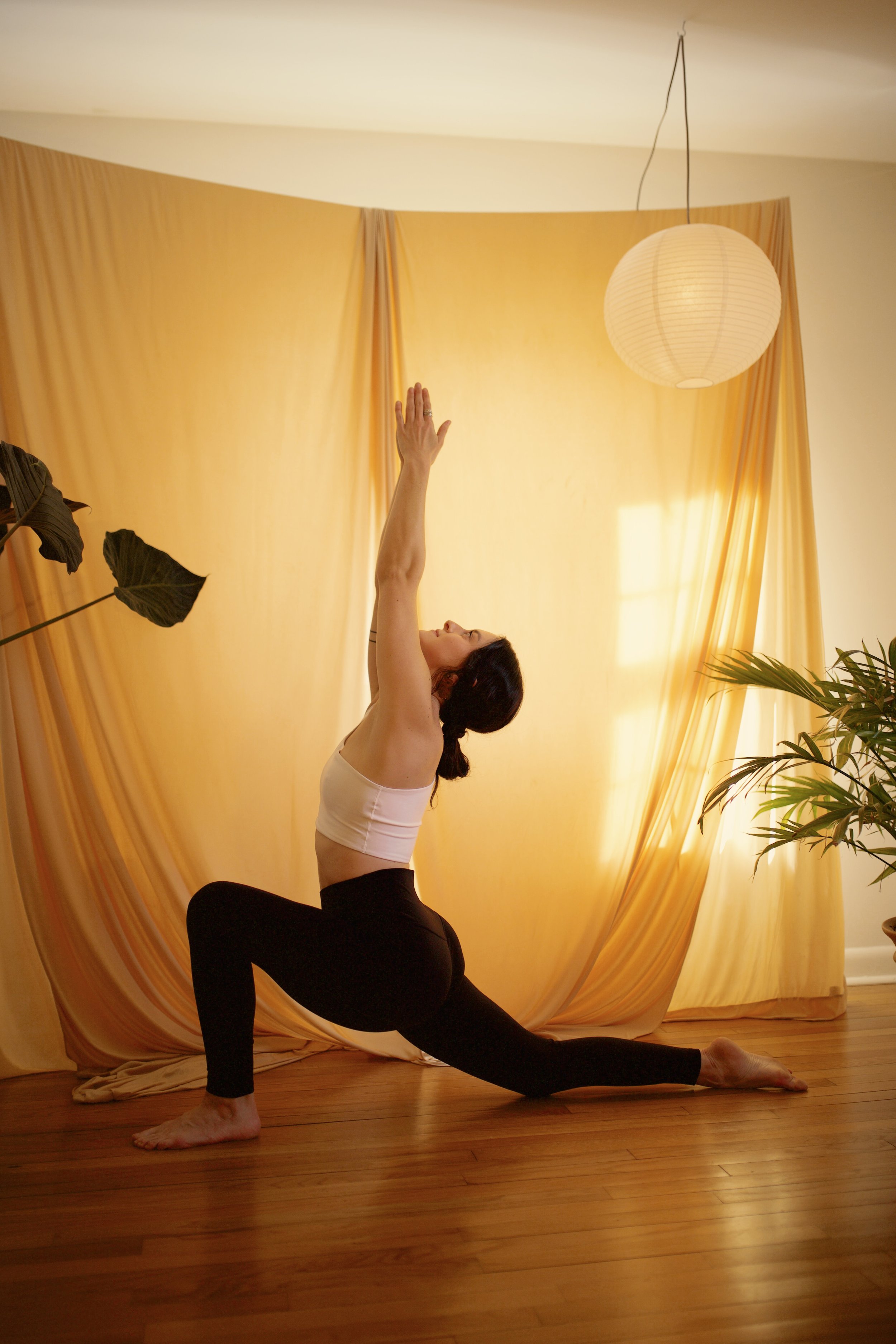 A woman sitting on the floor with her eyes closed in a meditative pose, with a translucent double exposure effect creating the illusion of movement.