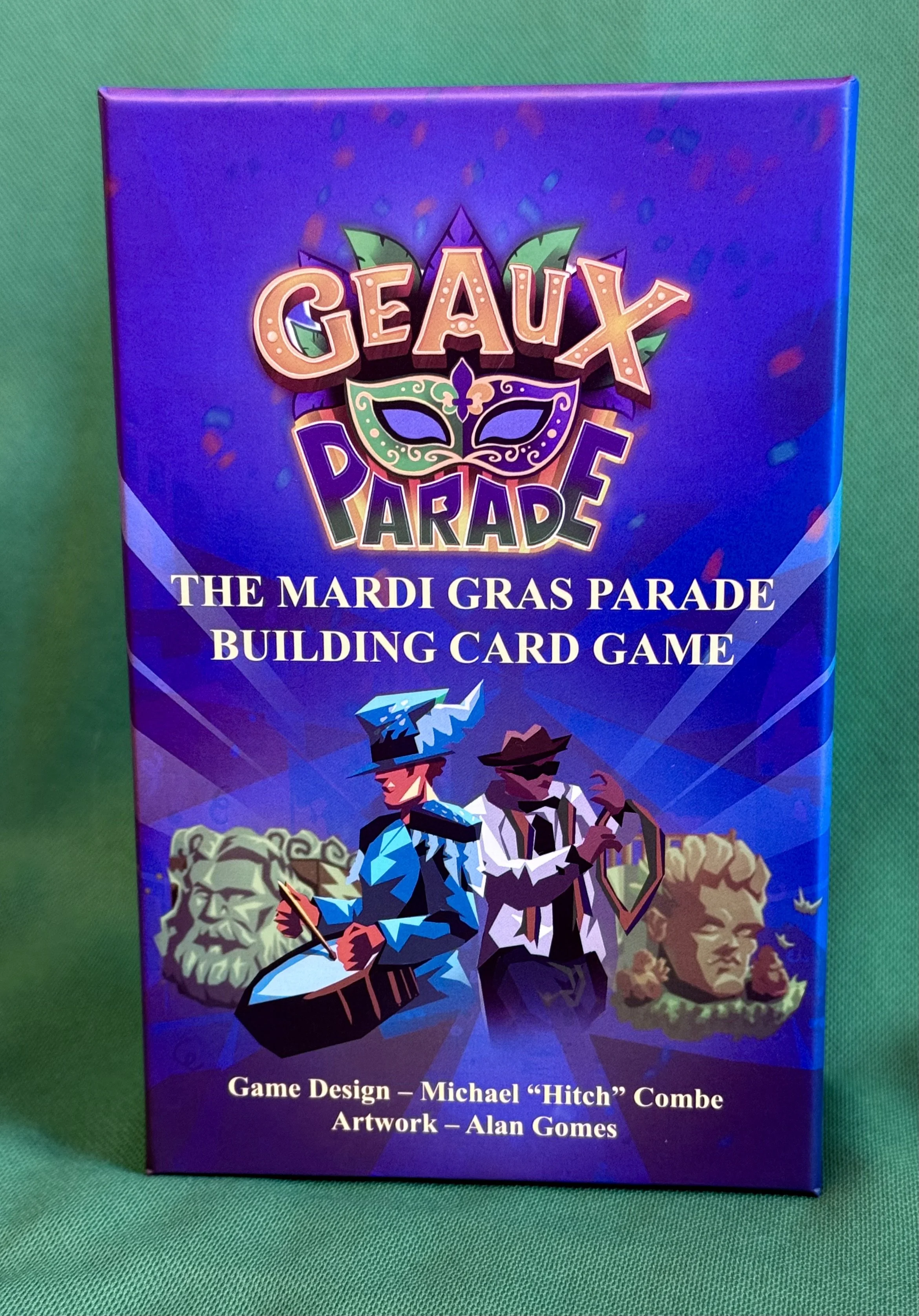 Box for GEAUX PARADE, a Mardi Gras-themed card game, featuring colorful characters and Mardi Gras floats.