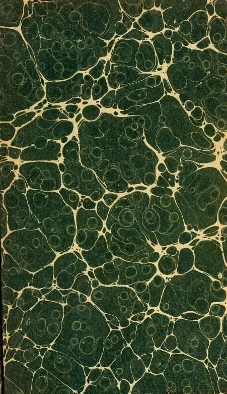 Close-up photograph of a dark marbled surface with beige vein-like patterns.