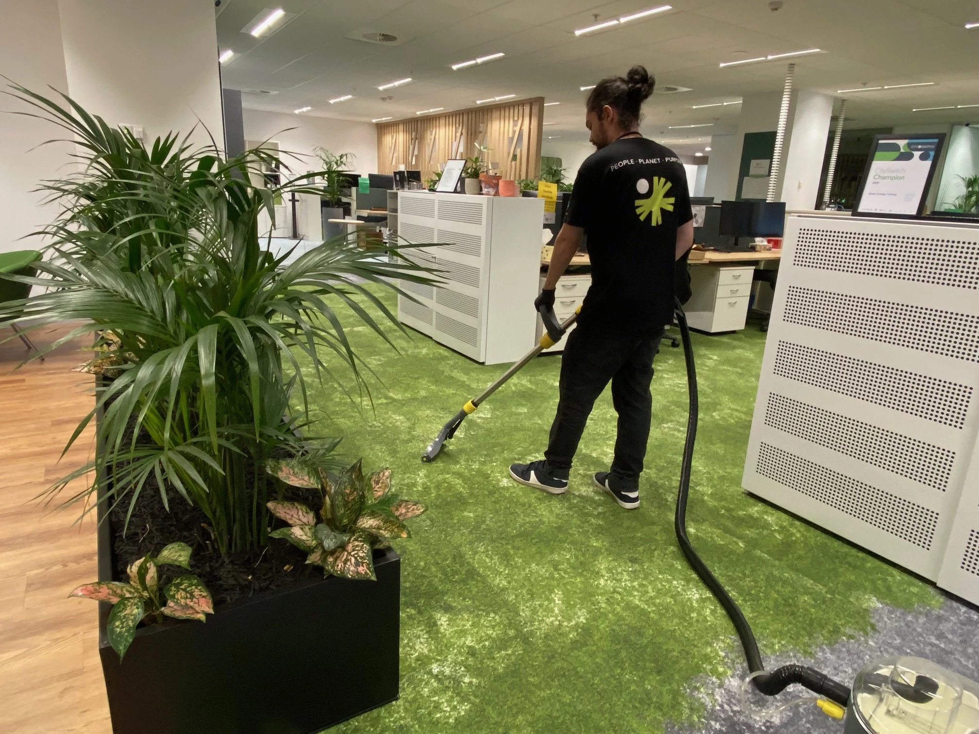 EarthWize cleaner performing commercial carpet cleaning in a Melbourne open-plan office