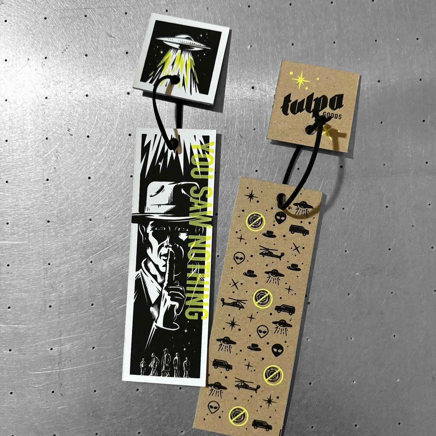 Have you ever experienced something strange? Has that experience been followed by more strange encounters with men in black suits, black unmarked SUVs and helicopters? Well these are the bookmarks for you!

Lovingly made from studio scraps and hand s