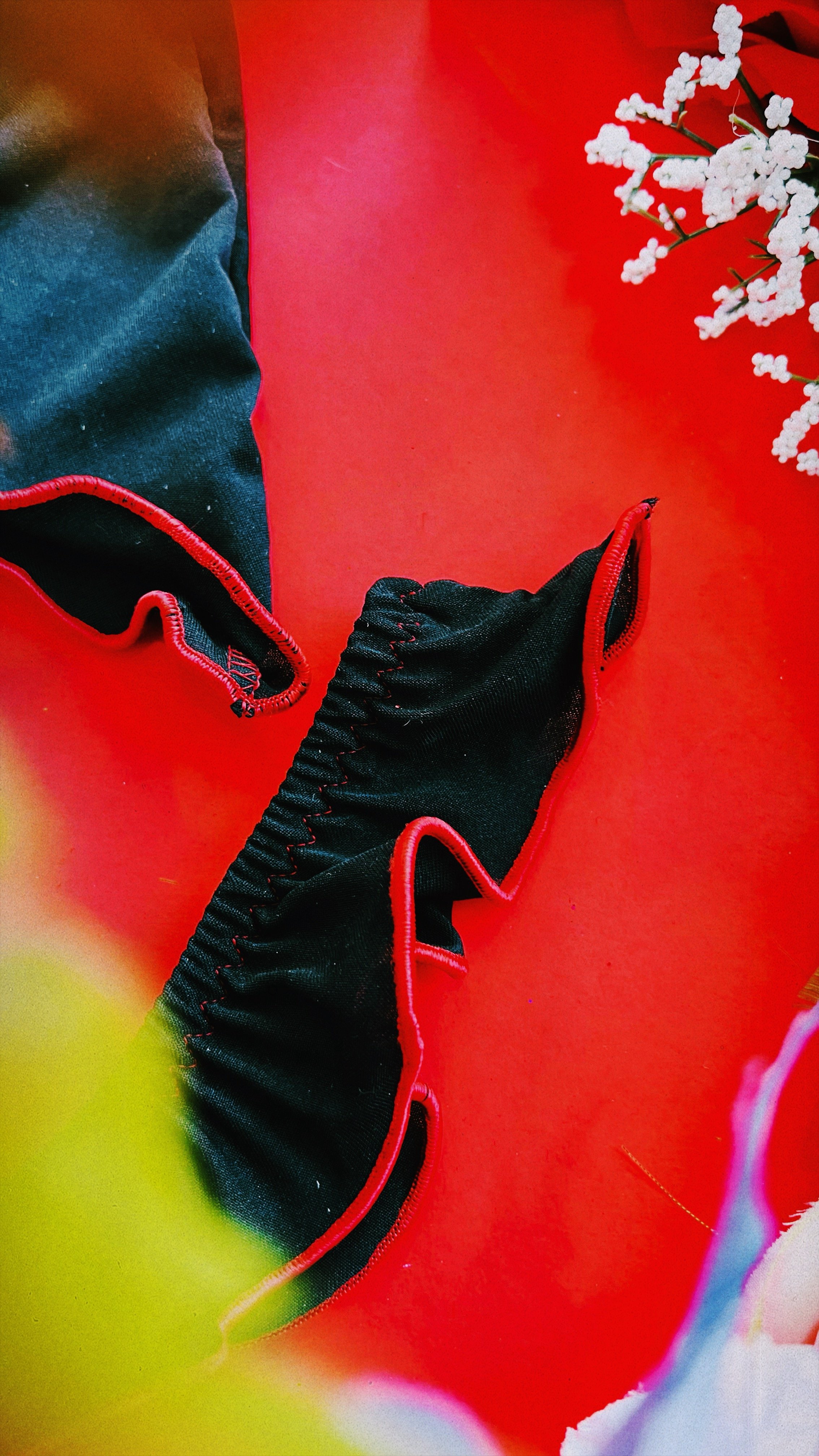 A focused shot on the intricate design of the lingerie bottoms, featuring elasticized detailing and a red bow for a playful touch.