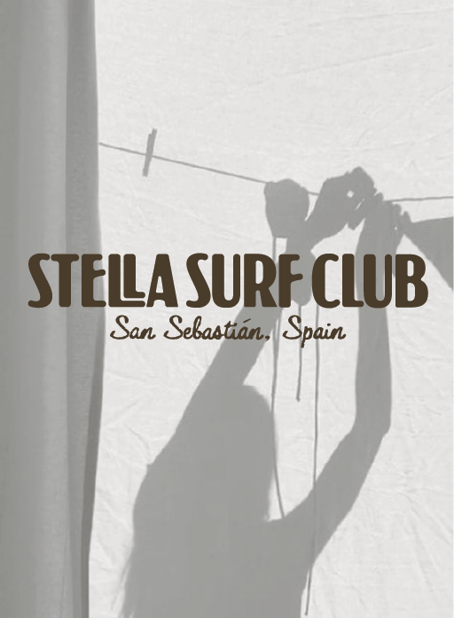 Shadow of a person hanging laundry on a clothesline, with text overlay reading "Stella Surf Club, San Sebastián, Spain."