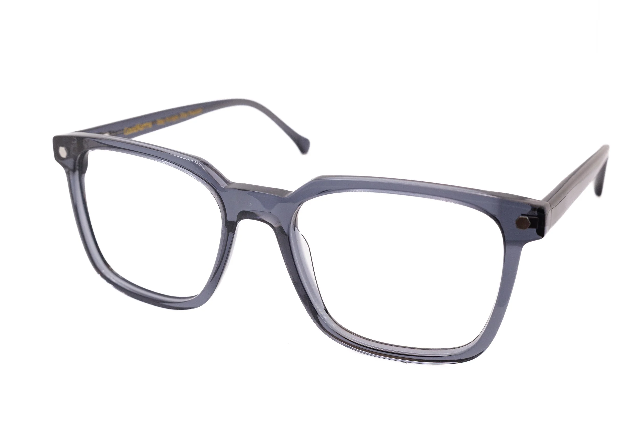 Close-up of a pair of eyeglasses with a dark, translucent frame and yellow writing on the temple arm, placed against a white background.